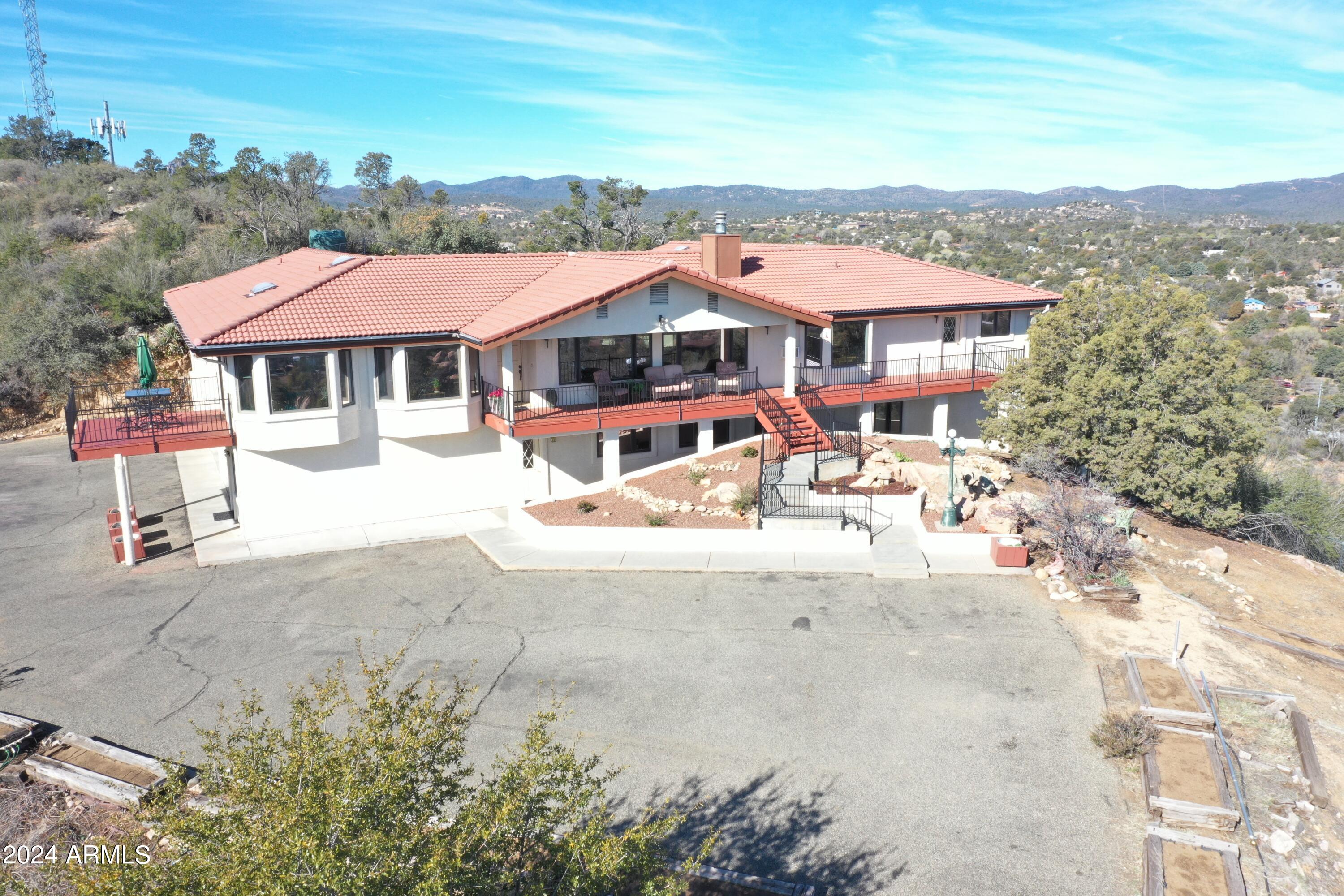 Don't miss out on this exceptional opportunity to own a residence nestled on 6.29 acres right in the heart of Prescott. This property offers versatile possibilities, whether you envision it as a multi-generational family home, a charming bed and breakfast, or a care facility. Boasting 5 bedrooms complete with en-suites and an additional 3 bedrooms, along with a grand total of 10 bathrooms, this home ensures comfort and convenience for all occupants.
The primary bedroom is a true retreat, featuring an expansive sitting area, a convenient kitchenette, washer and dryer facilities, a spacious walk-in closet, and even an indoor jacuzzi room for ultimate relaxation.