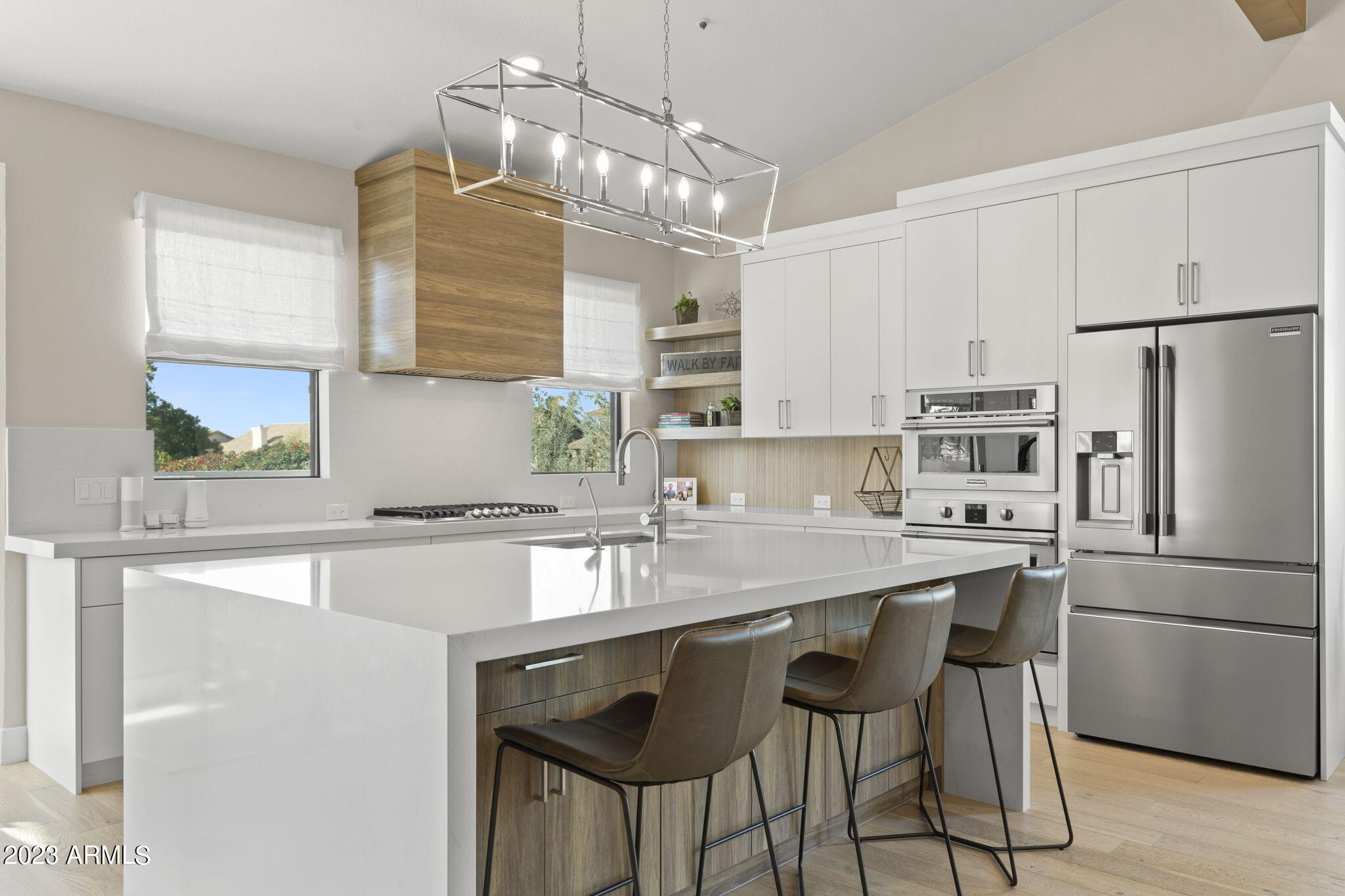 Nestled in the sought-after Sonoran Heights Community, this home has been expertly remodeled to showcase a stunning modern design. The split floor plan boasts 4 bedrooms & 2.5 baths, is airy and bright, with plenty of natural light. The gourmet kitchen is a chef's dream, featuring SS appliances, such as a 5 burner gas cooktop and double/convection ovens, quartz countertops, large island with breakfast bar & ample soft-close cabinetry. Beautiful oak hardwood flooring throughout with tile in the bathrooms and laundry room. Step out the 16 foot sliding door to the covered patio and entertainer's backyard with BBQ, putting green & sparkling pool. This home is an absolute must-see, showcasing both luxury and functionality in equal measure.