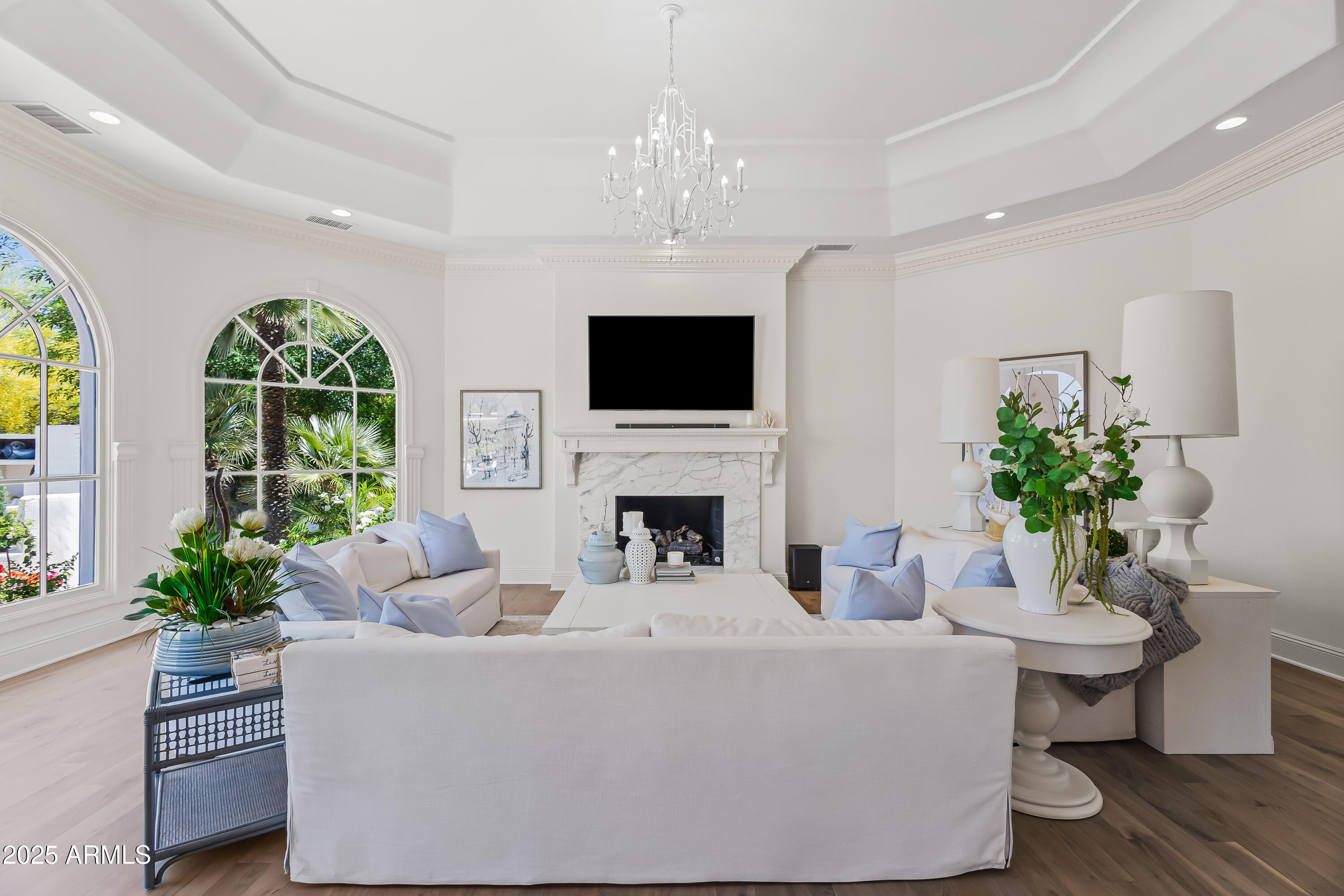 This Santa Barbara inspired 4-bedroom, 4.5-bath home sits on one of the most charming streets in Paradise Valley and offers backyard access to Camelback Golf Club. Inside, the home strikes a beautiful balance between style and comfort with thoughtful details throughout like a sweeping staircase, custom cabinetry, fresh paint and designer wallpaper. The layout flows easily through a light-filled living room, formal dining room, a spacious breakfast area, a cozy family room and office. The kitchen is complete with quartzite counters, custom cabinetry, Wolf appliances and rose garden views. The primary suite is a true retreat with a sitting area and private terrace overlooking the golf course and mountains. Each additional bedroom is spacious and ensuite offering space and privacy for all.