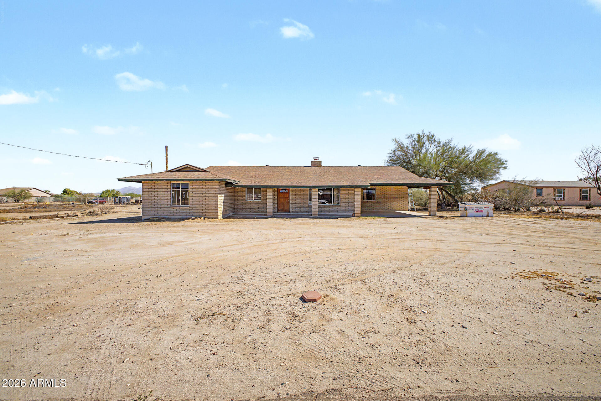 Set at the foothills of the White Tank Mountains, this highly desirable corner lot has over an acre of combined space to make your imagination come true. Entering from the extended front porch, the oversized flex room is perfect for an office, studio, or hobby space and shares the 2-way fireplace with a generous living area. There's plenty of space for guests with 4 bedrooms and 1917 sq ft and you'll love the extra savings each month with the owned solar system. Enjoy every evening watching Arizona sunsets under the extended covered patio in the fenced backyard. Lots J & E being sold together for a total of 1.158 acres. Don't let this opportunity pass you by!