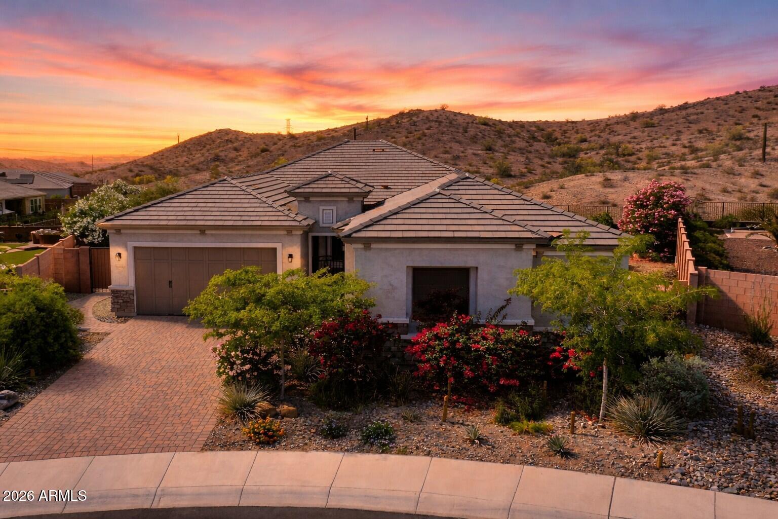 Sweeping desert views. Elevated design. One of Lucero's most unforgettable backyards. Located on a premium pie-shaped lot in the hillside neighborhood of Lucero, this modern elegant 4-bedroom, 2.5-bath home offers unobstructed western mountain and Sonoran Desert views that are truly among the best in the community. The backyard is a standout showpiece carefully curated for both beauty and function, with a heated spool featuring hydrojets and underwater lighting, Spanish-style gas fireplace, built-in outdoor grill, tiled seating area, custom fountain, putting green, artificial turf, low-voltage lighting, and lush desert-inspired landscaping that creates an intimate yet dramatic outdoor setting. Inside, custom architectural ceiling beams bring warmth and sophistication to the entry, kitchen and great room, while the open-concept layout creates seamless flow for everyday living and entertaining. The kitchen is beautifully equipped with stainless steel appliances, a large island, generous storage, and an oversized super-duper pantry.
The primary suite is positioned to capture the peaceful mountain views and offers a spacious bath with dual vanities, walk-in shower, and a large walk-in closet. This home also reflects meaningful investment in comfort and quality with upgraded west-facing windows for improved wind resistance, additional attic insulation, Culligan water softener, and reverse osmosis drinking system.
Located in the award-winning community of Estrella, residents enjoy two community centers, fitness facilities, lakes, 50+ miles of hiking and biking trails, pickleball, boating, fishing, heated pools with water slides, and the Nicklaus Design golf course managed by Troon. Residents enjoy access to two resident clubs, including the Starpointe Residents Club, featuring resort-style pools, a state-of-the-art fitness center, lakeside paths, and year-round community events such as live music and seasonal celebrations. Estrella's North and South Lakes serve as the heart of the community, offering scenic paths, water views, and gathering spaces that foster connection and relaxation.
An active lifestyle is built into daily life with miles of hiking and biking trails, parks, and sports courts for pickleball, tennis, basketball, and pickleball. Golf enthusiasts appreciate proximity to the Golf Club of Estrella, while others benefit from well-regarded schools, playgrounds, and community-focused programming. What truly sets Estrella apart is its thoughtful master planning homes are intentionally woven into preserved open space, creating a feeling of privacy and escape while still offering convenient access to shopping, dining, and major Valley freeways. The result is a community that feels like a retreat, yet remains connected to everyday needs.