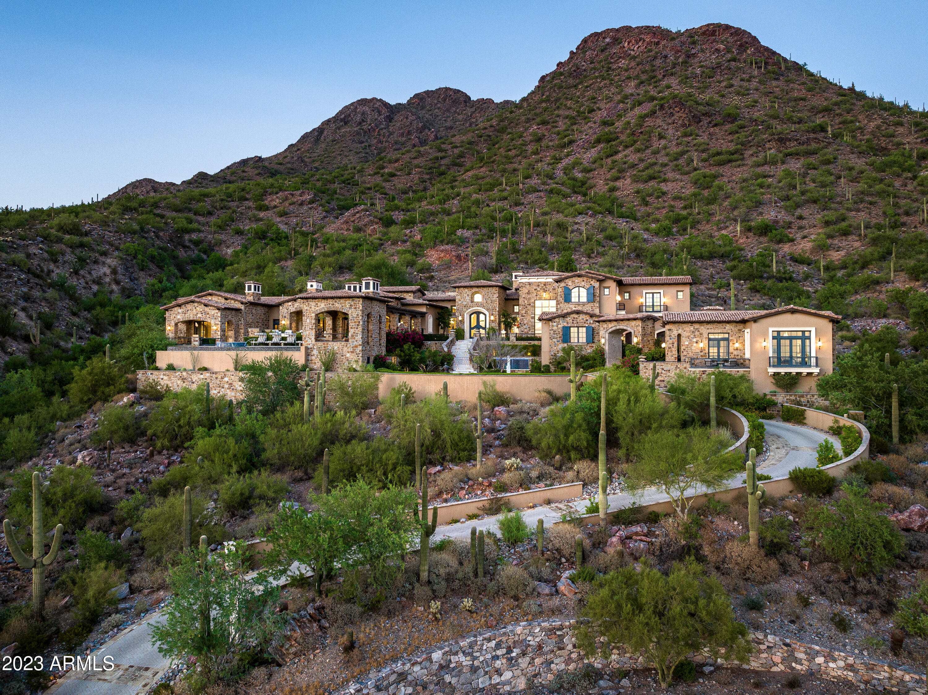 An architectural masterpiece emerges from the exclusive Upper Canyon of Silverleaf, where the nationally and internationally celebrated Castle on the Hill commands sweeping vistas across Scottsdale's most coveted terrain. This immaculate 2020 estate delivers over 13,600 square feet of unrivaled sophistication on 3.3 acres, showcasing panoramic views of the McDowell Mountains, Camelback Mountain, and brilliant city lights. From Swarovski crystal accents in the opulent primary suite to gold-inlaid floating staircases crowned with Italian chandeliers, every detail reflects extraordinary craftsmanship. A separate two-bedroom guest house.
