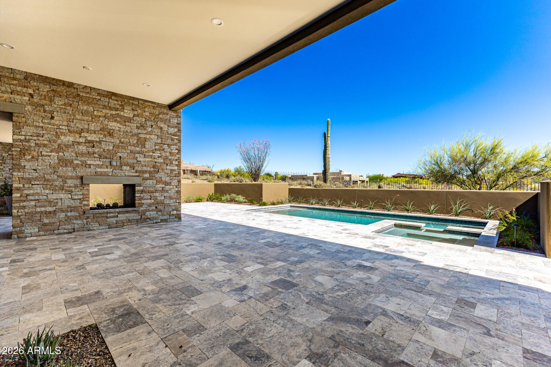 Another brand new, beautiful home just completed by Mortensen Signature Homes! Privacy with breathtaking mountain and sunset views. Walls of glass flood the spacious great room with natural light while seamlessly connecting indoor and outdoor living. The high-end kitchen is equipped with Sub-Zero refrigeration and Wolf appliances, ideal for both everyday living and entertaining. A Desert Mountain builder golf membership is available with Desert Mountain Club approval. Whole - home designer furnishings package available for a truly turnkey opportunity. Wood flooring runs throughout the home, complemented by a tumbled travertine patio. Step outside to expansive covered outdoor living areas featuring a fireplace, built-in BBQ, and a sparkling PebbleTec pool and spa with an in-floor cleaning system perfect for enjoying Arizona's outdoor lifestyle.
The front and rear yards are fully landscaped with mature plantings and an automatic drip irrigation system, making the home move-in ready and easy to maintain.