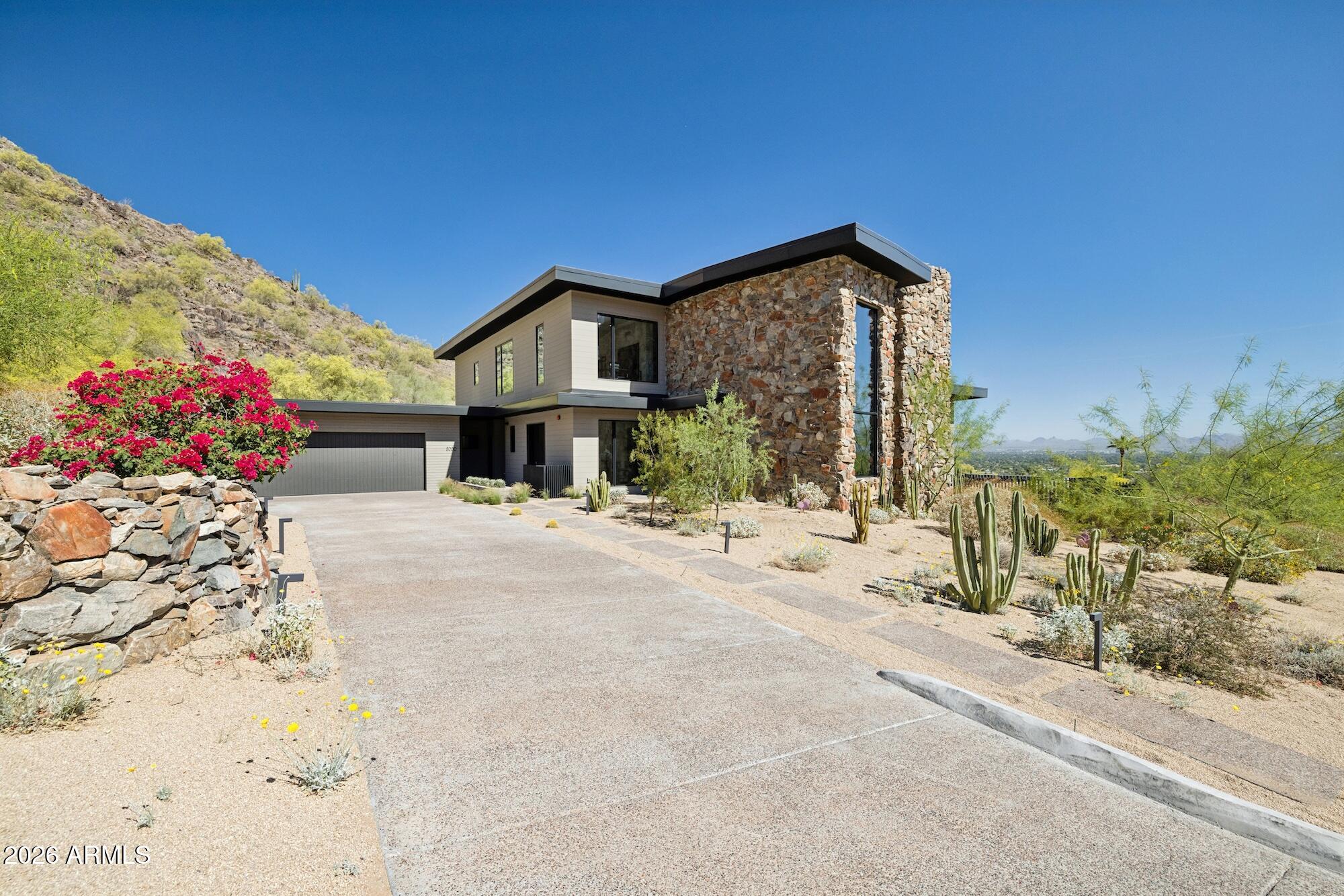 NOW PRICED AS ONE OF THE BEST OPPORTUNITIES IN SUNSET HILLS WITH A SIGNIFICANT $300K PRICE IMPROVEMENT AND $350K+ IN UPGRADES. NEVER LIVED IN.

Welcome to one of the most prestigious hillside settings in Paradise Valley, where elevated living meets breathtaking, unobstructed views. Positioned to capture sweeping 270 degree panoramas of Scottsdale, the McDowell Mountains, and Arizona's pristine high desert, this residence delivers the privacy, serenity, and exclusivity that define true hillside living. Living in Paradise Valley offers a lifestyle unlike anywhere else, quiet, elevated, and removed, yet just minutes from the best dining, shopping, golf, and resorts in Scottsdale and Phoenix. It's where privacy meets convenience, and every day feels like a retreat. Walls of glass create a seamless indoor outdoor experience, while an expansive view deck sets the stage for unforgettable sunrises, sunsets, and sparkling city lights. Inside, the chef's kitchen has been redesigned to enhance natural light and flow, featuring custom cabinetry, updated counter tops, and designer glass pendant lighting. Open concept living spaces are complemented by updated lighting, ceiling fans, and smart home features, creating a warm yet sophisticated atmosphere. The primary suite offers a private retreat, while bathrooms feature new vanities, fixtures, and custom closet systems. Technology upgrades include whole house audio, security, WiFi, and AV enhancements for modern living. Step outside to a resort style backyard with upgraded pool equipment, including heating and cooling capabilities for year round enjoyment. Extensively updated and move in ready, this home captures the essence of Paradise Valley hillside living. private, elevated, and truly exceptional.