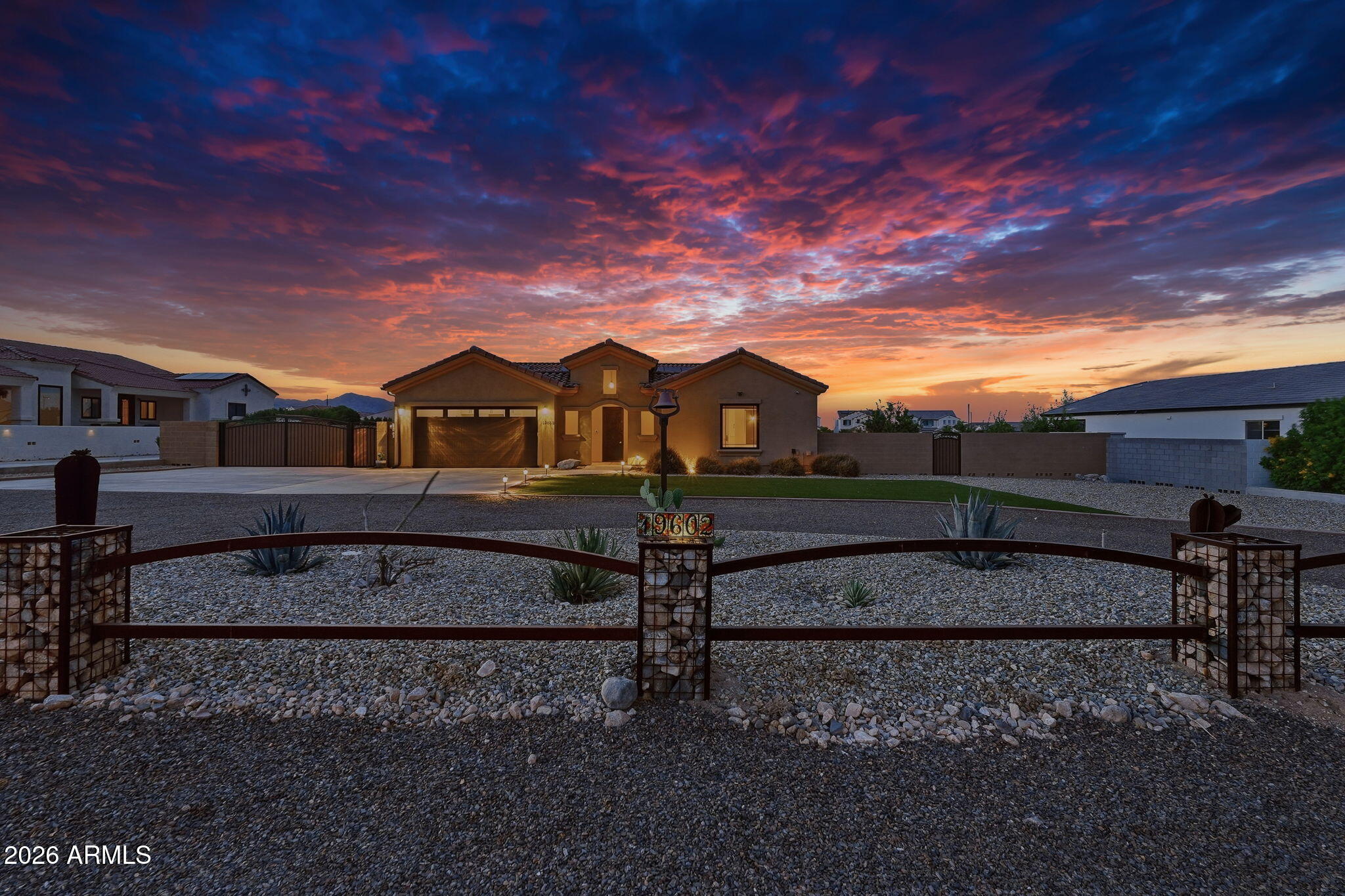Discover the allure of this remarkable custom home, nestled on just under an acre of land, featuring owned solar panels, a rooftop deck, and a refreshing pool. The property boasts a circular driveway and an inviting interior courtyard, complemented by a charming casita and a bar area equipped with a wine-beverage fridge.

With 3 bedrooms, 3 bathrooms, & den, this stunning residence captures attention from the moment you enter the custom wrought iron front door. Inside, you'll be greeted by soaring 10-foot ceilings and a den ideal for an office or sitting area. The great room features sliding glass walls, seamlessly connecting to the dining area and a gourmet kitchen, which is a chef's dream with stainless steel appliances, spacious cabinetry w/crown molding & island. Retreat to the master suite, complete with a private exit, an immaculate bathroom featuring separate vanities, a soaking tub, a shower, and an expansive walk-in custom closet. The vast backyard is an entertainer's paradise, showcasing a rooftop deck with breathtaking panoramic views of the White Tank Mountains and the downtown Phoenix skyline, along with a misting system and built-in speakers on the patio.

This property also includes a casita, an inviting pool, an RV gate with parking setup, complete with clean-out and power. Enjoy the beauty of citrus trees, a turf area, and the stunning rooftop deck that offers unparalleled views of both the mountains and the city. Additionally, the home features brand-new windows throughout. Don't miss the opportunity to make this extraordinary property your own!