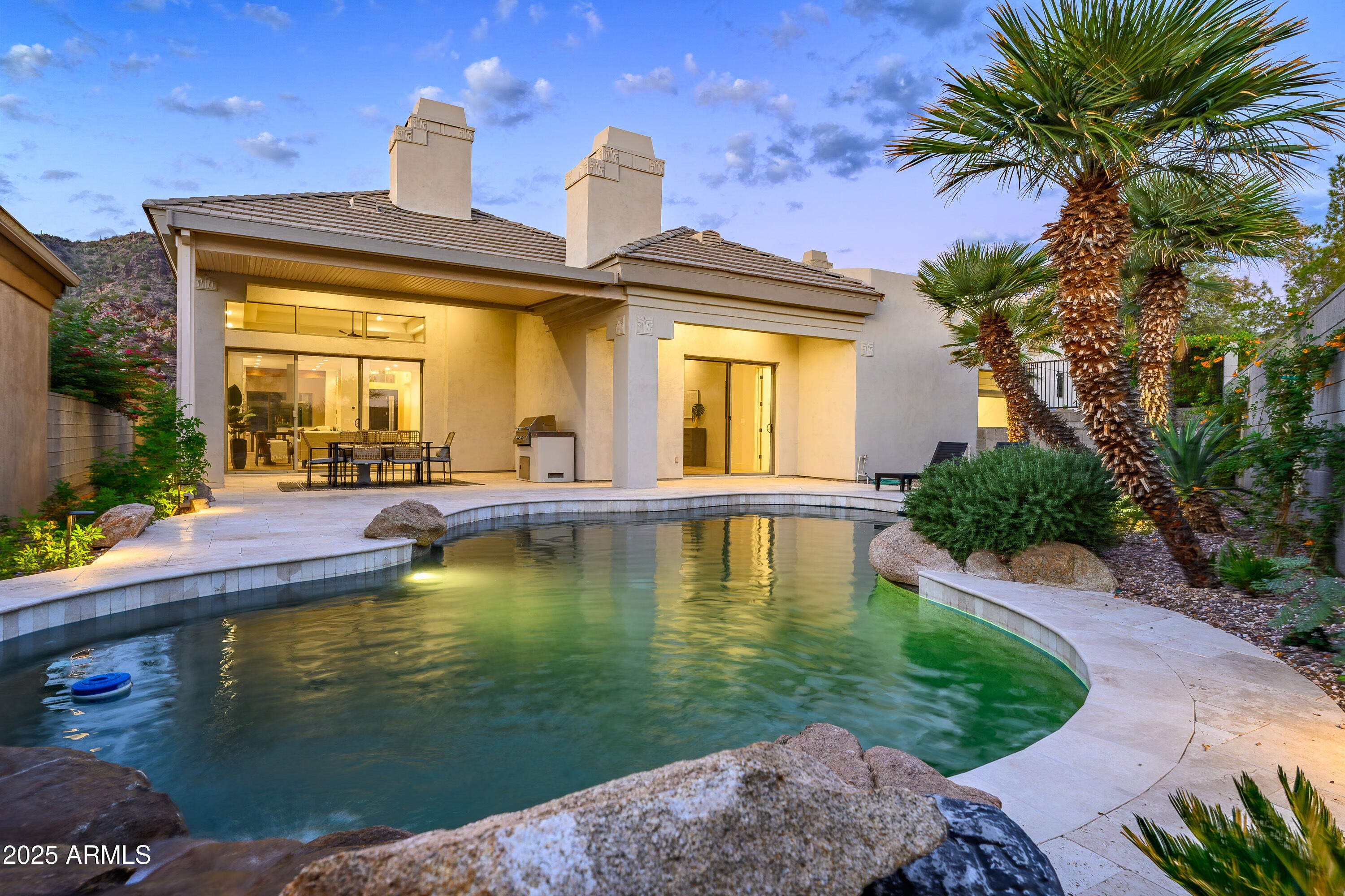 This designer-renovated 3BR/3.5BA single level contemporary jewel, nestled inside the prestigious 24-hour guard-gated Biltmore Hillside Villas, features an open plan with elegant kitchen and dining room with beautiful mountain views. The expansive great room with vaulted ceilings leads to a covered patio and oasis-like pool with waterfall, making this an entertainer's dream. With 3 en suite bedrooms, the spacious master suite with sitting areas and gorgeous bath is a comforting retreat. With high-end finishes, appliances and designer touches throughout, this warmly sophisticated home is a must see. The pet friendly neighborhood features miles of sidewalks, with trail access to the Mountain Preserve and Biltmore Resort, and is minutes from the best activities & luxuries in the Valley.