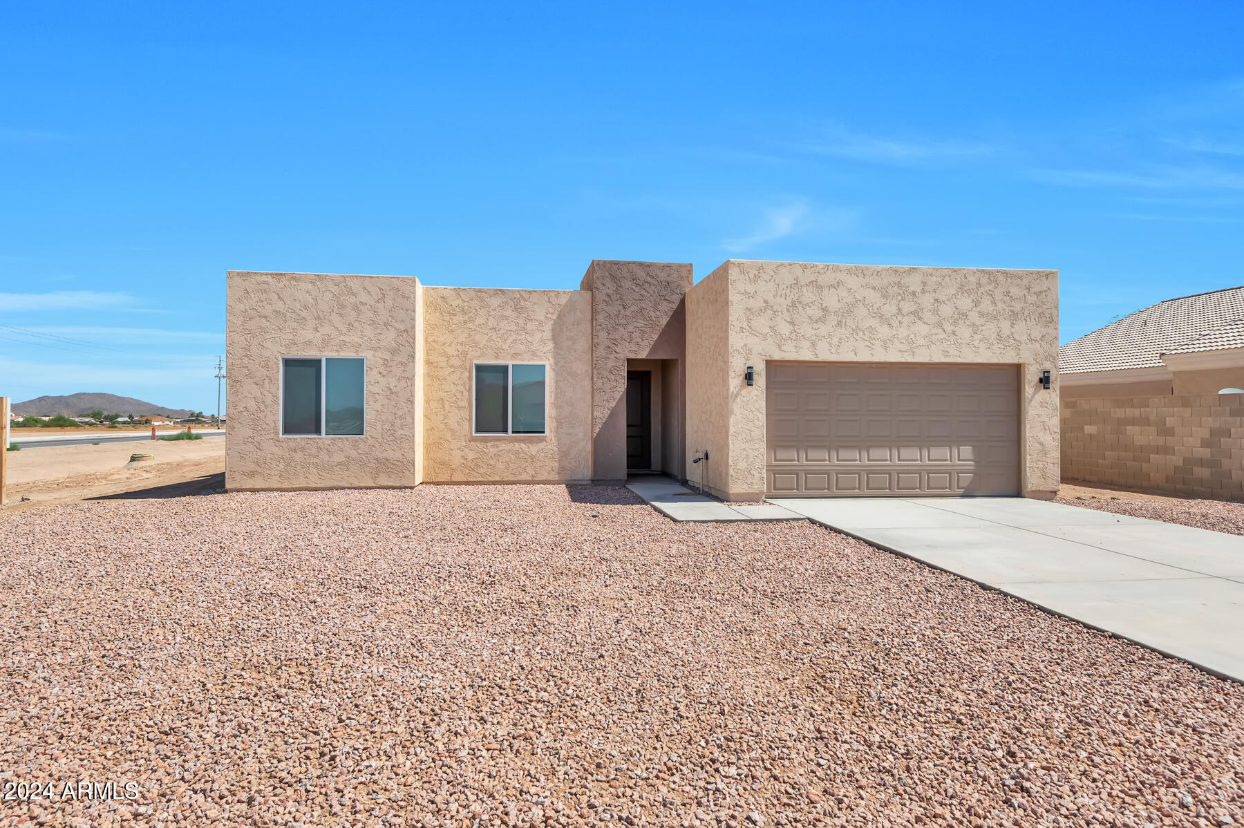 NEW NEVER BEEN OCCUPIED HOME! Must see open concept design with 15 ft high ceilings in the living room and 8 ft high entry door. The kitchen contains soft close shaker cabinets, large waterfall kitchen island, quartz countertops, stainless steel appliances, & walk-in pantry. With 4 beds & 3 full baths, this home offers ample space for the family. Walk-in closets in every room, providing abundant storage and organization. Enjoy indoor-outdoor living & entertainment with 12 ft patio door and ceiling fans to cool off. Park your vehicles in the 8 ft garage. Stay comfortable year-round with ceiling fans in every room & cozy up by the fireplace in the living room. Vinyl plank flooring & upgraded window coverings add the perfect finishing touches. Retreat to the master bathroom & indulge in the walk-in rain shower, double sink, & private toilet room. The home is preplumbed for a water softener. Spray foam insulated home which can save utilities up to 50% compared with standard insulation! Located just a few miles away from Lucid, Nikola, & Kohler.

NO HOA telling you what you can and can't do! 

Please note: select rooms have been digitally enhanced with premium virtual furnishings to showcase the scale and versatility of the living spaces