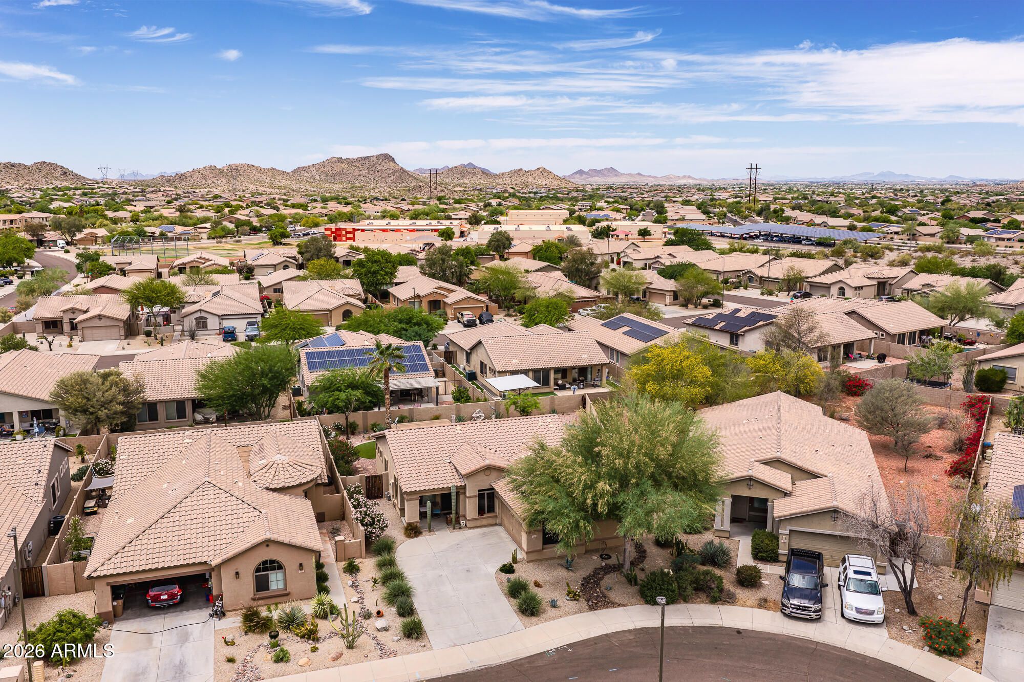 Welcome to this beautifully upgraded single-story home in highly sought-after Estrella Mountain Ranch! Featuring 2 bedrooms plus a den, 2 bathrooms, and situated on a spacious lot, this home offers the perfect blend of comfort, style, and Arizona outdoor living. The backyard is an entertainer's dream with low-maintenance artificial turf, a putting green, cozy fire pit area, and an additional storage shed. Inside, you'll find custom touches throughout including tile flooring, stunning stonework accents, an upgraded fireplace, and a custom bar area in the dining space perfect for entertaining guests. The spacious primary suite features upgraded closet systems and a beautifully remodeled bathroom complete with a large custom tiled walk-in shower. The versatile den offers the perfect space for a home office, workout room, or guest area. This home can also be sold fully furnished, making it an incredible turnkey opportunity for full-time residents, winter visitors, or investors. Located in the award-winning Estrella Mountain Ranch community, residents enjoy access to incredible amenities including resort-style pools, fitness centers, scenic lakes, hiking and biking trails, fishing, and championship golf at the Jack Nicklaus-designed Golf Club of Estrella. The community also offers abundant HOA activities and events including concerts, holiday celebrations, fireworks shows, farmers markets, and more.