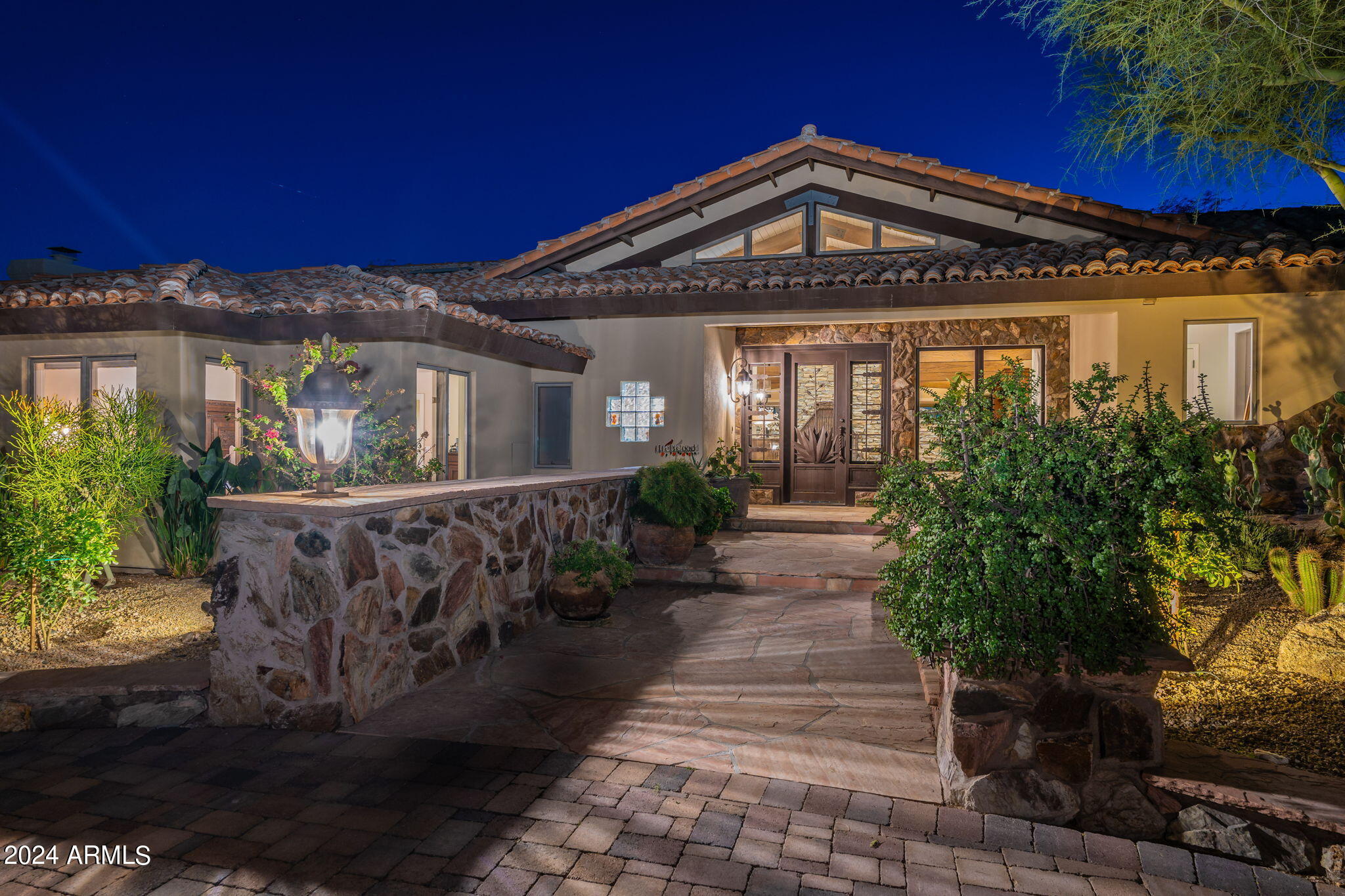 Nestled in the Exclusive Pinnacle Peak Area of North Scottsdale this 10-acre estate enjoys the prestige of an address synonymous with luxury living and close to world class golf courses, restaurants, and shopping. The beautiful landscaped gated entry welcomes you with perfectly manicured grounds and pavered driveway circling around a majestic specimen mesquite tree. The interior layout of the 3 bedrooms plus office 5 bath home emphasizes an open plan with seamless flow between living spaces. The vaulted and beamed ceilings create an airy and spacious atmosphere throughout the home. Retractable glass doors seamlessly connect indoor and outdoor living spaces blurring the lines between the luxurious indoor and scenic outdoor space. The outdoor living spaces rival the finest resorts in Scottsdale, featuring an intimate covered patio space with outdoor kitchen, fountain, and lighting for the perfect spot for Al Fresco dining. The impeccably landscaped grounds boast a botanical garden symphony with meticulously manicured spaces and an array of flora creating a true oasis of serenity and beauty. The huge artificial turf area in the rear yard, heated pool, Michael Phelps spa, and two fire features make this back yard oasis the perfect spot to entertain year-round. While you enjoy your well-appointed home your horses will love their own equestrian paradise. Separate gated entry for barn area with easy access for large rigs and delivery of hay and supplies.  Plenty of room to circle around no backing up needed. 7 Stall center aisle barn with covered runs off of the stalls all matted, with excellent lighting, automatic waters, rubber pavered aisleway. Even a "Big Ass" fan to keep the airflow in the hot summer months. Tack room with deep sink, water heater for hot baths, fly system and mist system. The Grooming/Wash stall with rubber pavers and drain.  The Arena 125x225 is leveled with good sand footing and excellent drainage, lights for early morning and evening training sessions, and sprinkler system to help maintain arena surface and provide dust control. A spacious turn out paddock pipe fenced on the back 5 acres of land allows for multiple horses to be turned out together. Need a shop or more storage?  The 25'x50' storage building adjacent to the barn is your answer. Tall enough to accommodate a lift. Drive thru capability.  Bathroom with shower. Oversized door to allow for a big RV or Horse Trailer.  Additional Large Covered area adjacent which allow for hay storage, or horse trailer, RV covered parking area. This is a one of kind property close in with country feel but all the intown amenities within 1 mile from the home. Don't miss this opportunity