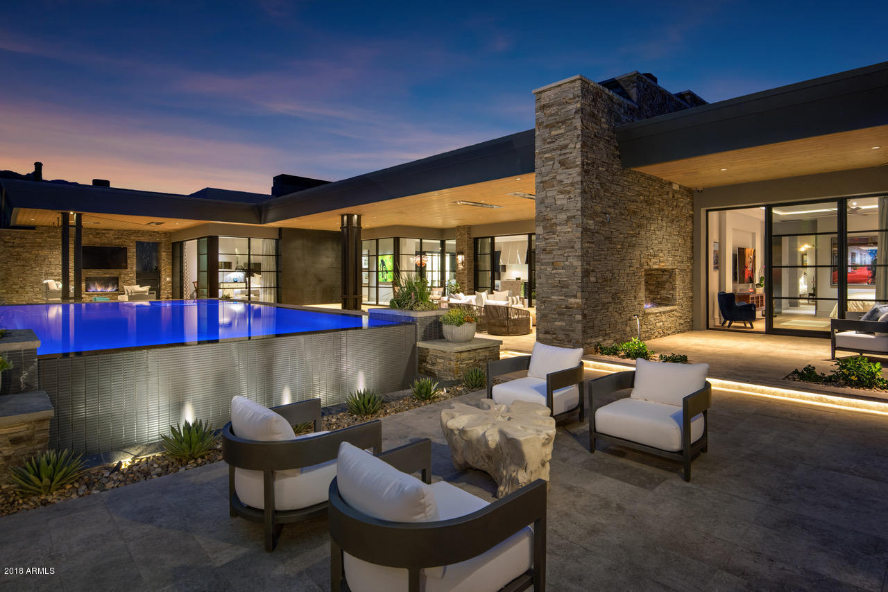 Featured Covers for Luxury Home Magazine, & Finest Golf Properties. Mariola House is a timeless masterpiece of modern design and craftsmanship in the picturesque community of Saguaro Forest at Desert Mountain. This 5800 sq ft home offers four ensuite bedrooms, an office, two lounges, and wet-edge salt pool/spa on 2.49 acres with striking mountain views. Each detail has been methodically chosen for a lifetime of art and function. The private master apartment features its own private lounge, designer closet, and bath which rivals any Scottsdale spa. An Epicurean Suite anchored with a LaCornue 165 range is the envy of this fashionable community. An expansive outdoor living space with Egyptian Limestone boasts a lightscaping package transforming this estate into visionary night art. Stunning Mariola House is smart and energy efficient. User-friendly technology with voice or app functionality enhances this home's modernity. The owned solar system, tankless water heaters, and seer-26 Lennox units are some of the fundamentals helping to reduce your carbon footprint.