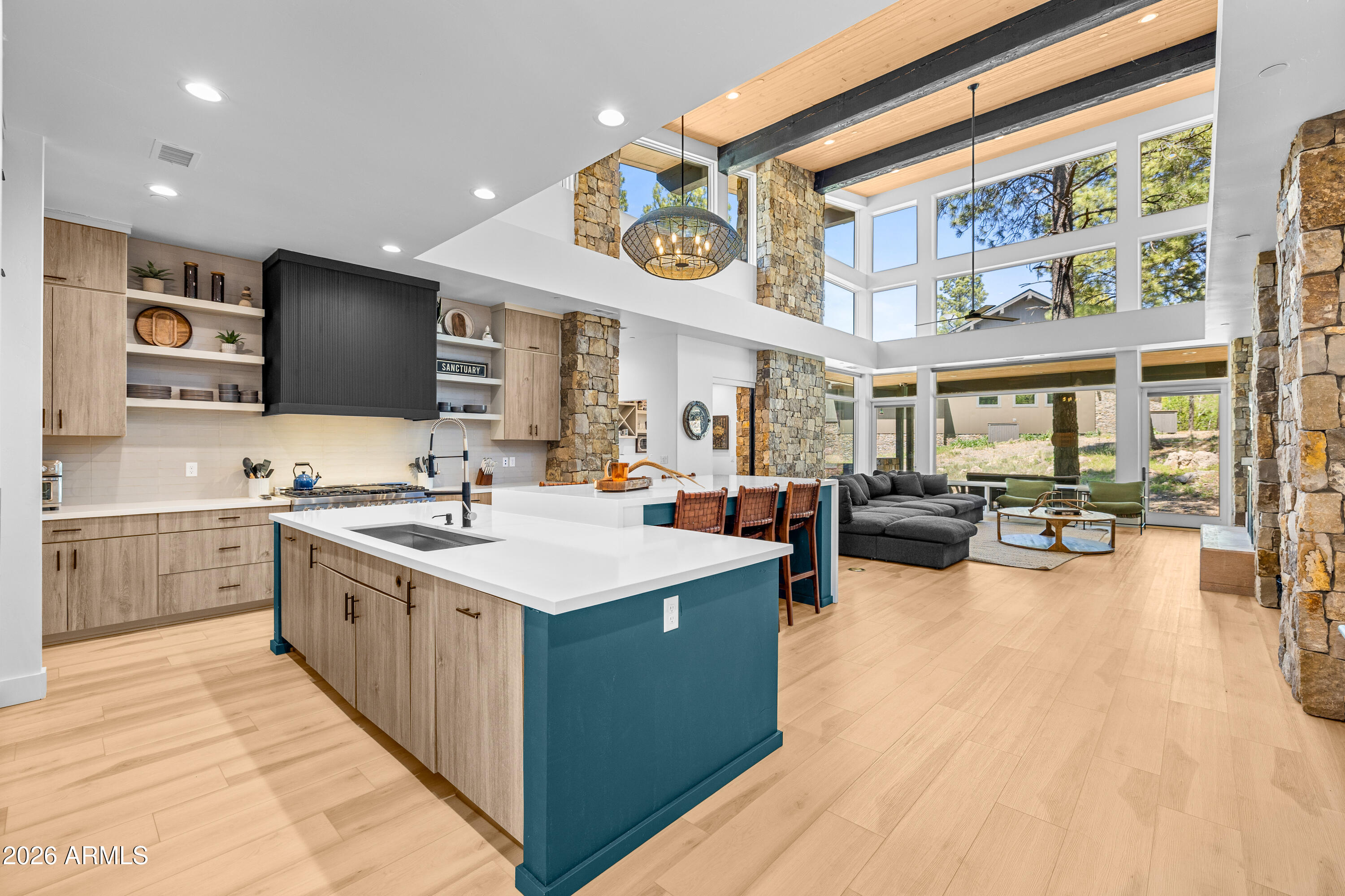Welcome to 3560 S Clubhouse Circle - Single-level home with a desirable split floor plan, newly built in 2023, offering a modern cabin aesthetic surrounded by natural beauty. The light-filled great room is a standout, framed by expansive windows that capture serene tree views and anchored by a dramatic floor-to-ceiling metal-surround fireplace. Luxury plank flooring runs throughout the home, enhancing both style and durability.. The custom kitchen is designed for entertaining, featuring a large island with extended bar seating and high-end finishes. A walk-in wet bar just off the great room includes dual beverage refrigerators—perfect for hosting. The primary suite is a private retreat with dual vanities showcasing white oak cabinetry and black hardware, a private water closet, walk-in closet, and a separate soaking tub and shower. A secondary bedroom offers an ensuite bath and private access to the rear patio, while the third and fourth bedrooms share a Jack-and-Jill bathroom.

Additional highlights include a dedicated laundry room with cabinets and sink, plus a versatile bonus room off the mudroom ideal for a home office, desk space, or crafting. Three interior steps lead to the primary suite, secondary ensuite, and great room areas, subtly defining the living spaces while maintaining single-level convenience.