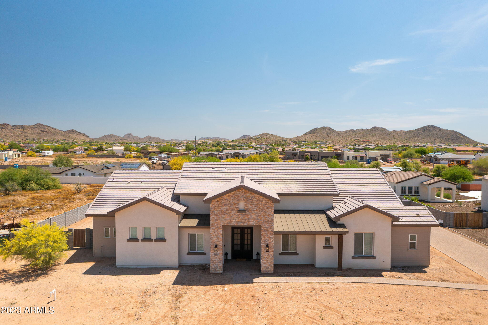 North Peoria custom luxury home situated on a prime 1 acre lot with endless possibilities! Built in 2019, this home provides 4,025sf of living space, 5 bedrooms, 3.5 baths, and a large 4-car garage. High-end upgrades inside include 14-foot coffered ceilings, a large pocket door, custom iron front doors, and a gourmet Kitchen. The Kitchen is every chef's dream, showcasing a commercial-size fridge, oversized island, premium quartz counters, pot filler, and premier GE Cafe and Monogram appliances. Unwind in the resort style oversized Primary Bathroom, featuring dual rain shower heads, body sprayers, a hand-held wand in the shower and a freestanding soaking tub! Convenient location just minutes from popular shopping destinations, hiking trails and Paloma Park. No HOA! Front and Backyards are a mostly blank slate, ready for you to design your dream layout and customize however you would like. Extra long driveway on side of home is great for parking large vehicles or trailers, and there is a large RV gate that opens to the backyard near the garage. The Backyard has an approximately 70' deep by 50' wide concrete pad already poured for a large RV garage, and the pad is pre-plumbed for a bathroom!