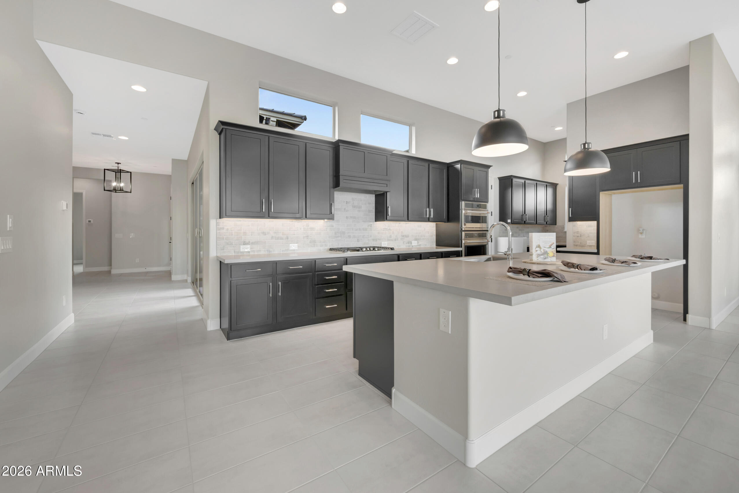 BRAND NEW single level plan with 3 beds, 2.5 baths, study, gorgeous interior courtyard and 2 car garage; both secondary beds have large walk-in closets; upper and lower cabs with sink in utility room; gorgeous gourmet kitchen with views to the extended covered patio; dark cabinets, a custom tiled backsplash and quartz tops; huge pantry and GE Cafe stainless appliances with gas cooktop; 2-tone paint, upgraded tile, carpet and pad throughout; owner's bath with dual sinks, quartz countertops and incredible tiled walk-in shower, large walk-in closet with built-in seat and mirror; 12' sliding glass door access to the beautiful interior courtyard; 2x6 construction and extensive new home warranty.
