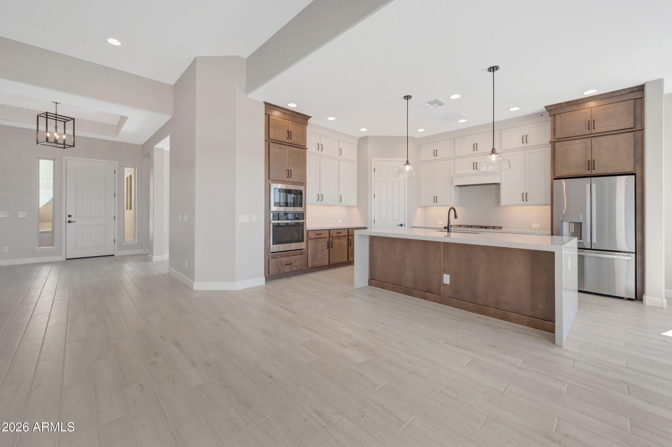 BRAND NEW gorgeous single level open plan w/4 bed, 3.5 bath with study and 3 car garage; 12' ceiling and 12 sliding glass door in family room; chef's kitchen with both light and dark cabinets to the ceiling, quartz tops and huge waterfall island with pendant lighting; GE stainless appliances including refrigerator; tons of storage including walk-in pantry; extended covered outdoor living area in private backyard; utility cabinets and sink with direct access to owner's walk-in closet; spa-like owner's bath with floor to ceiling tiled super shower w/added raincan showerhead; bed 2 & bed 3 share a jack n jill bath w/bed 4 having an ensuite bath; tray ceiling in study; 10' SIDE GATE; 2x6 CONSTRUCTION AND EXTENSIVE NEW HOME WARRANTY.