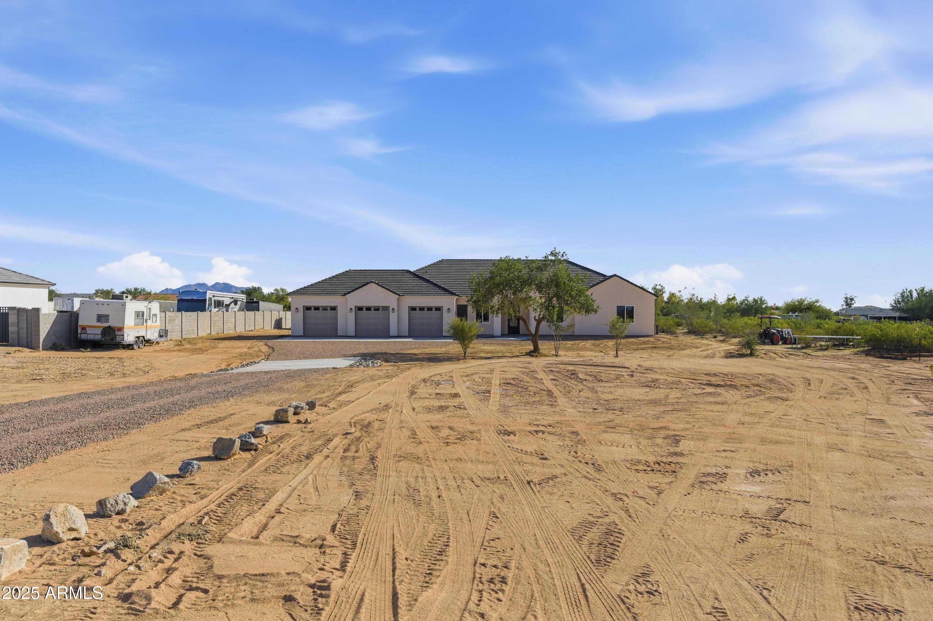 Welcome home to this exceptional, newly built 3051sqft custom home on just over an acre of horse property with no HOA! Spacious and airy, this home boasts 10ft flat ceilings, extra wide hallways, 4  generous bedrooms, 3 bathrooms and an office/den with separate entrance. Gourmet kitchen features quartz counters, island with breakfast bar, 42'' cabinets, tile backsplash, stainless appliances including  wall oven, and a walk-in pantry. The large primary bedroom has access to the covered rear patio, an over-sized walk-in closet and en-suite with double sinks, tile shower and stand alone tub. Huge 1045 sqft 3 car garage. Conveniently located with stunning desert/mountain views, this amazing home is just minutes from shopping, restaurants and Casa Grande's most northern I-10 on ramp.