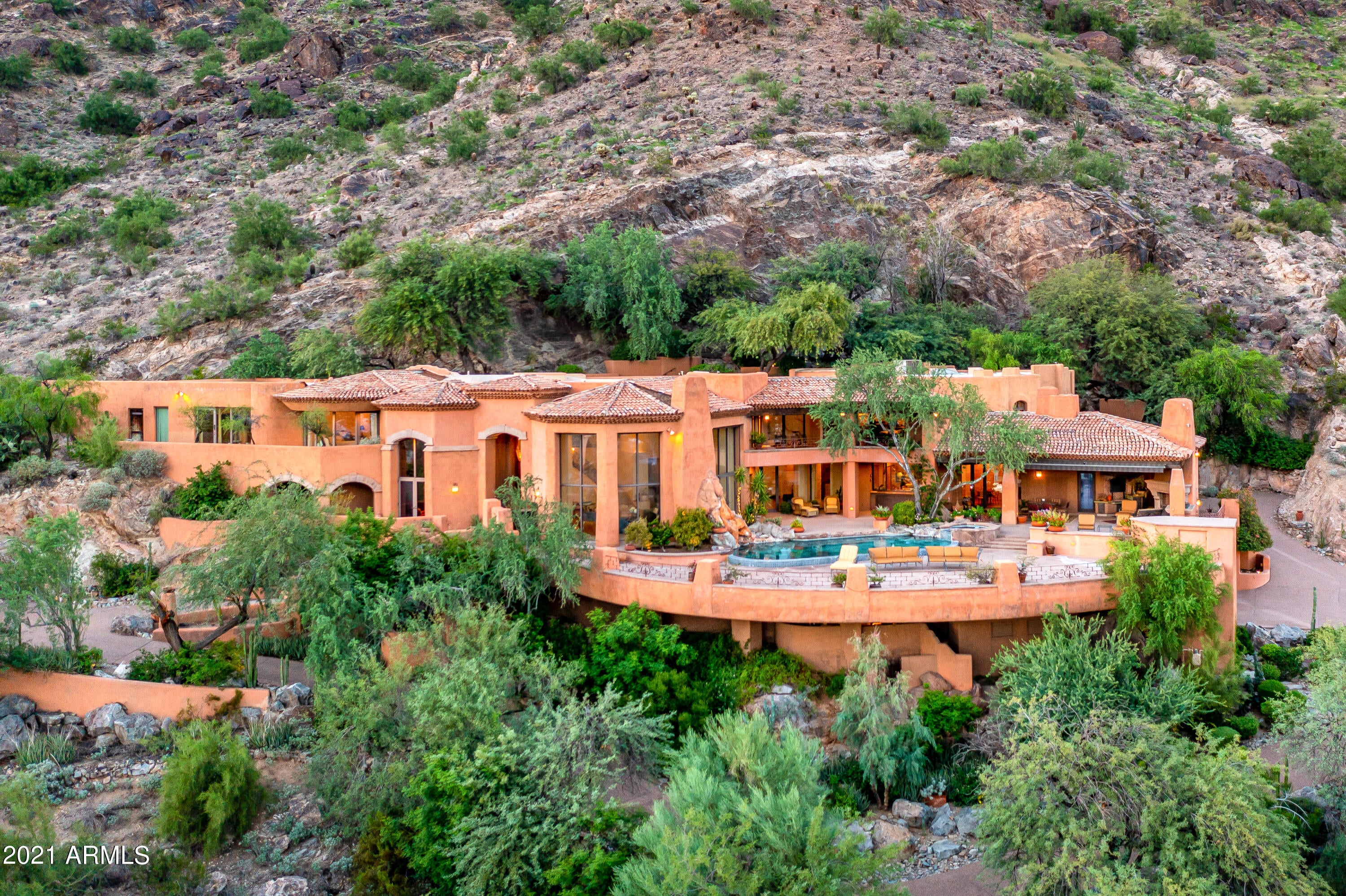 The MOST STUNNING full view of Camelback Mountain and the south valley! 180 Degree elevated views from Mesa to the downtown Phoenix skyline.  This exquisitely built european estate was designed by the highly acclaimed Nash McDaniel.  You see quality and thought throughout with much potential to enhance the european lifestyle or modernize it. There was great effort in developing this 4 plus acre hillside lot with two driveways and parking areas beyond the private gate.  Private patios sit up against Mtn Mummy and a spacious entertaining outdoor space overlooks the most covetted view in the valley with a pool, waterfall, BBQ grill.  4 ensute bedrooms, a flowing staircase, a private full sized elevator, a dumb waiter, fully wood paneled Library, Den, Hobby room, Safe room... So many additional features to show you.