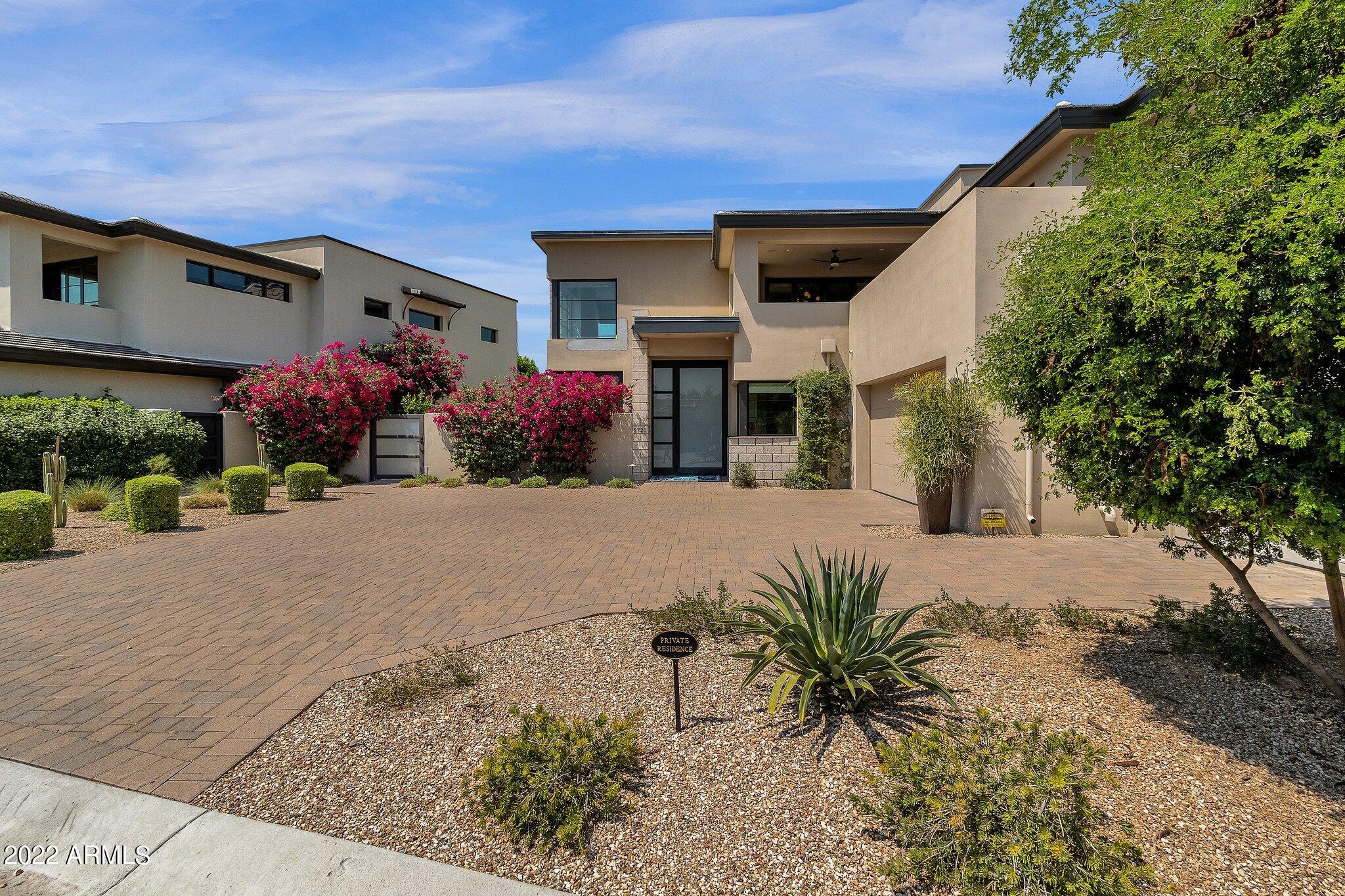 THIS TWO STORY HOME BUILT BY CULLUM HOMES AND DESIGNED BY THE RENOWNED ARCHITECTURAL FIRM CANDELARIA DESIGN ASSOCIATES. GREAT ROOM WITH FIREPLACE AND SLIDING DOORS OUT TO COVERED PATIO AREA. FORMAL DINING AREA. KITCHEN AREA WITH ISLAND, EAT-AT BAR, LARGE PANTRY. WOLF STAINLESS STEEL APPLIANCES. OWNERS SUITE ON MAIN LEVEL WITH WALK-IN CLOSET, DOUBLE SINK VANITY, SEPARATE TOILET ROOM, FREE STANDING TUB AND SEPARATE SHOWER. ELEVATOR TAKES YOU UPSTAIRS TO THE ADDITIONAL BEDROOMS, COMPLETE WITH OWN BATH SUITES.  BAR  WITH SLIDING DOORS TO OUTDOOR PATIO. DEN ALSO ON UPPER LEVEL WITH A COVERED PATIO. ADDITIONAL POWDER ROOM ON BOTH FLOOR AND LAUNDRY ON MAIN LEVEL. THREE CAR GARAGE TO PROVIDE PLENTY OF PARKING.  THE SUNSET VIEWS OF CAMELBACK!