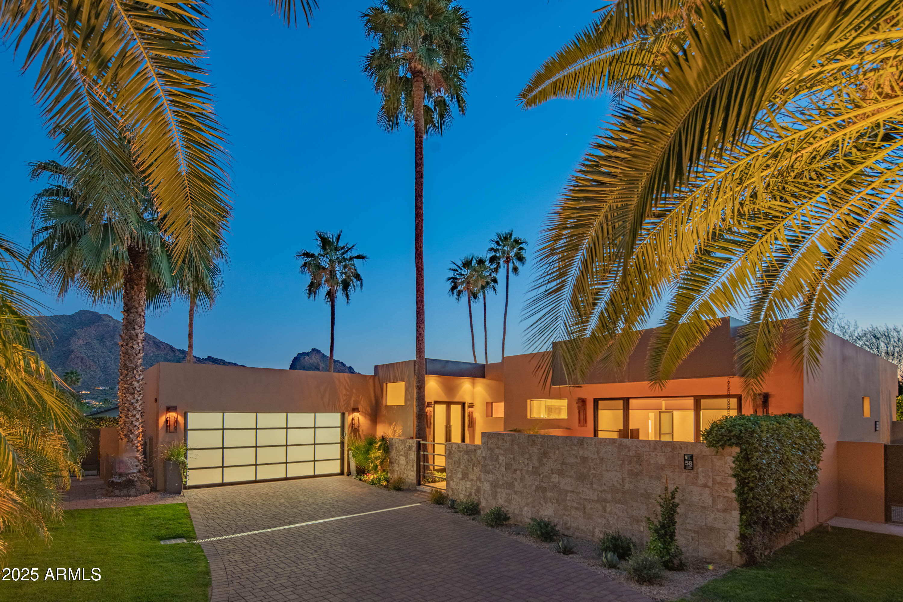 Welcome to Paradise Valley's best kept secret, situated within the guard gated community of Colonia Miramonte and nestled between the historic Camelback Inn and El Charro. This magazine worthy home was featured in Phoenix Home and Garden and is also the former home of Hollywood actor Charles Boyer, who chose the home for its privacy and intimate Camelback Mountain views. This special home exudes a refined elegance. Completely reimagined from top to bottom and featuring soaring 12' ceilings throughout; along with custom floor-to-ceiling glass doors which flood the home with natural light and open to the backyard offering a perfect blend of indoor/outdoor living. A true chef's kitchen overlooks the great room and comes equipped with a Thermador gas range, Miele cappuccino machine, SubZero glass wine cooler and refrigerator/freezer drawers. The massive fireplace sits as the living room's centerpiece and provides an inviting setting to entertain around. The spacious primary suite has its own private courtyard complete with fire feature and a fountain. While the spa like primary bath boasts a soaking tub, glass shower, dual vanities and a custom walk in closet. Relax and bask in the views of both Mummy and Camelback Mountains from one of the private patios with the tranquil sounds of the fountains in the background as you enjoy a glass of wine and soak in the sunset. Order room service or walk to the Camelback Inn when you're ready to enjoy a world class dinner, here it is all at your beckoning.