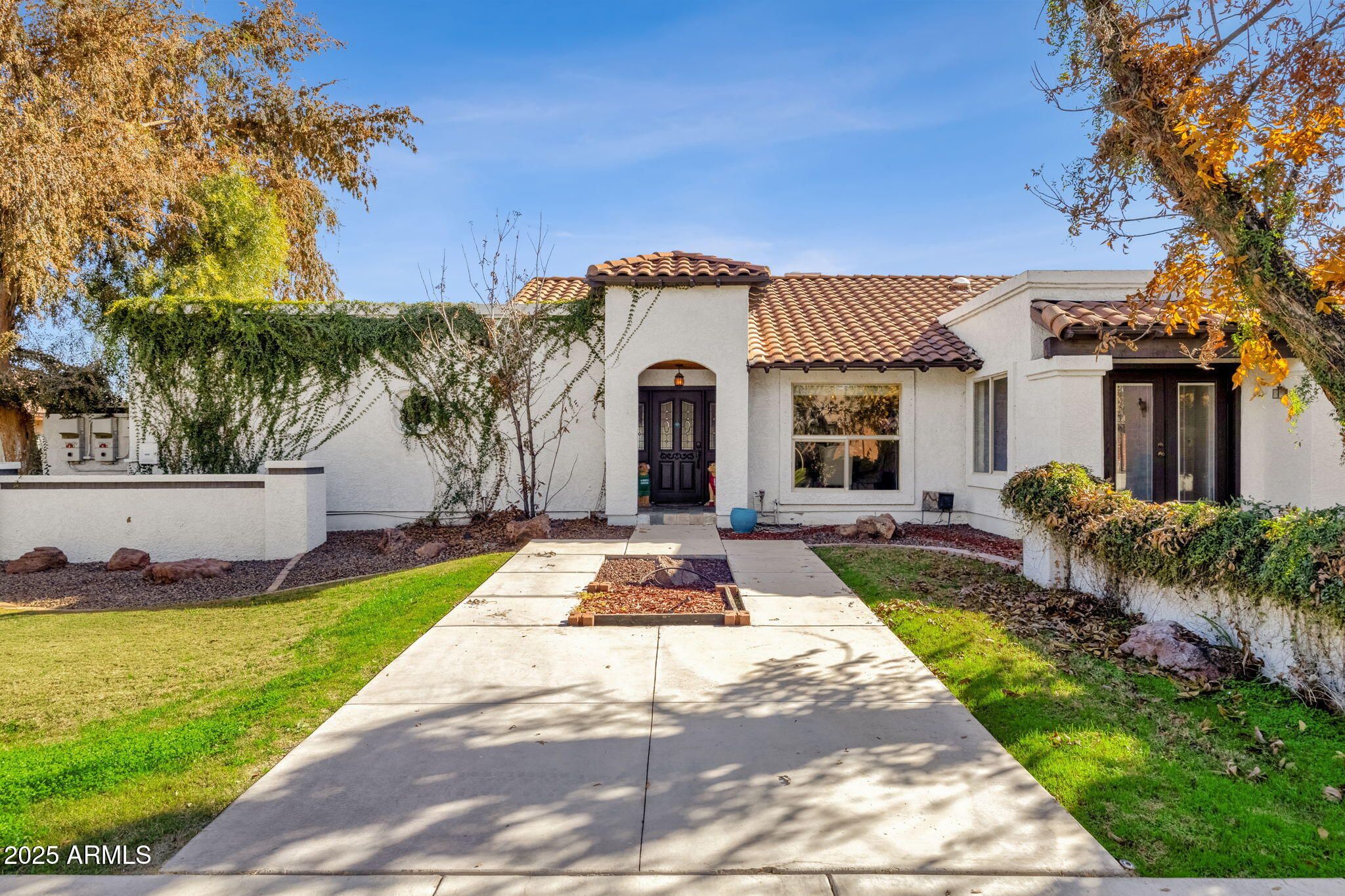 Nestled within the sought-after custom home enclave of The Groves of Gilbert, this expansive residence features generous space, timeless character, and everyday comfort.

Offering 5 bedrooms, 4 bathrooms, and 3,432 square feet, the home is thoughtfully designed for both everyday living and memorable entertaining, with generous proportions and timeless architectural details throughout.

The interior welcomes you with beautiful tile flooring, skylights that flood the home with natural light, and energy-efficient dual-pane windows that enhance comfort year-round. Two distinct fireplaces—including a striking two-way design—anchor the living and family rooms, creating warm, inviting gathering spaces. A dedicated den provides an ideal home office, study, or flex space, adding versatility to the floor plan.

At the heart of the home, the kitchen features light-grained cabinetry, granite countertops, stainless steel appliances, an eat-in dining area, a breakfast bar, and ample pantry storage. The kitchen flows seamlessly into the main living areas, making it ideal for entertaining.

The oversized primary suite is a private retreat, featuring a spacious walk-in closet and a well-appointed ensuite bath with dual vanities, a soaking tub, and a separate shower. Additional bedrooms are comfortably sized and thoughtfully positioned to accommodate guests or multi-generational living.

Step outside to a backyard designed for Arizona living at its best. Enjoy an extended covered patio, a built-in BBQ area, and a sparkling pool complete with a water feature and slide, a true outdoor oasis for relaxation and fun. The property includes a 3-car garage, providing ample space for vehicles, storage, or hobbies.

This exceptional home combines custom-home charm with modern enhancements in one of Gilbert's most desirable neighborhoods.