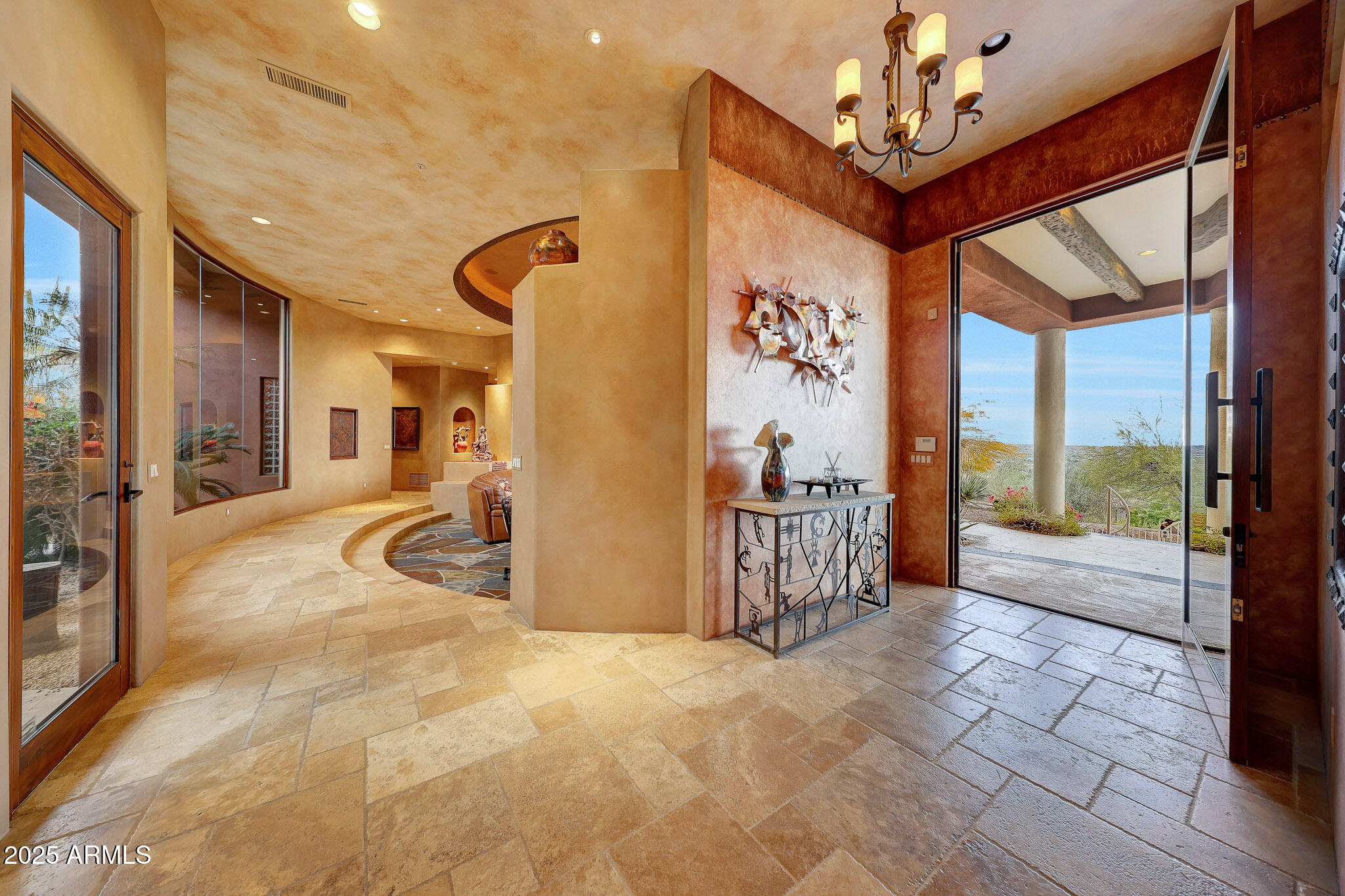 Nestled high on Black Mountain in the prestigious, gated Carefree Grand View Estates, this stunning southwest contemporary home offers an unparalleled lifestyle with sweeping city views, vibrant sunsets, and twinkling lights that create a breathtaking backdrop every evening. The 5,447sf residence is beautifully designed to blend modern luxury with the natural beauty of the surrounding hillside. Step inside to find a spacious circular living room with entertaining bar and breakfast room, gourmet chef's kitchen with picturesque windows. The main level is designed for convenience and luxury, offering a private primary suite with expansive views, a guest suite, a dedicated office, and a bonus room--perfect for a media room or additional living space. A seamless flow leads to the outdoor oasis, where the backyard is a resort-like retreat. The second level includes two luxurious en-suite bedrooms, a cozy sitting room with its own kitchenette, and a spacious view deck patioideal for relaxing or hosting guests while taking in the stunning vistas. Outside, the grounds are equally impressive, set on 1.88 acres of hillside terrain. The negative-edge saltwater pool appears to cascade into the horizon, complemented by a 20-foot waterfall flowing from the mountainside. Additional features include a fire pit and ample patio space for dining and lounging, creating the perfect atmosphere for outdoor living and entertaining.

The home also boasts a three-car garage and is perfectly situated to offer privacy, tranquility, and the ultimate in scenic desert living. This is a rare opportunity to own a one-of-a-kind residence in one of Carefree's most sought-after communities.