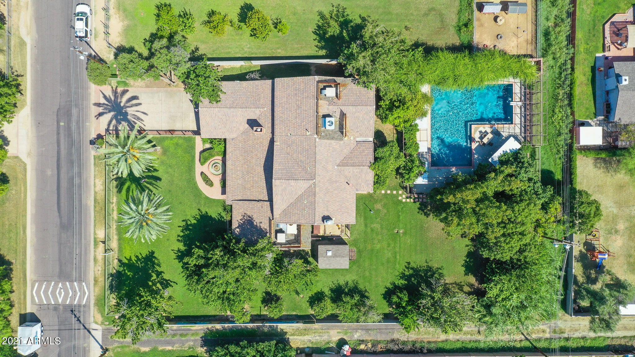 Family home expanded & remodeled 1995 by prev. owner. Added  app 1283 ft, n/s exposure, many unique features. Added upgrades, plant screen fencing around heated diving pool, roof, screened a/c & evap coolers, hardwood flooring, brass rails from Rome, entrance has fountain, plant screen fencing in front & block fencing west side. 
Antique stain glass recovered from Churches.  Mahogany wood fireplace & beveled mirrors front room. Family Rm high ceiling & wood fireplace, Kitchen Cherry Cabinetry, corian counter tops, prototype gates on several doorways, breakfast bar & formal dining room . Upstairs master bedrm, with gas fireplace, master bedroom bedroom set will convey, bathroom garden tub w/jets, shower stall. 2 back Upstairs bdrm have balconies. have balconies. Gameroom and half bath accessible from covered back patio, peach, pecan, apple, fig, lime, lemon, orange,mulberry, pomegranate trees, grapevine and bamboo field. Irrigated property with drip/sprinklers in front and back. Extended two car garage. Indoor laundry with laundry chute. Must see this loved family home to appreciate the unique home layout and backyard.
