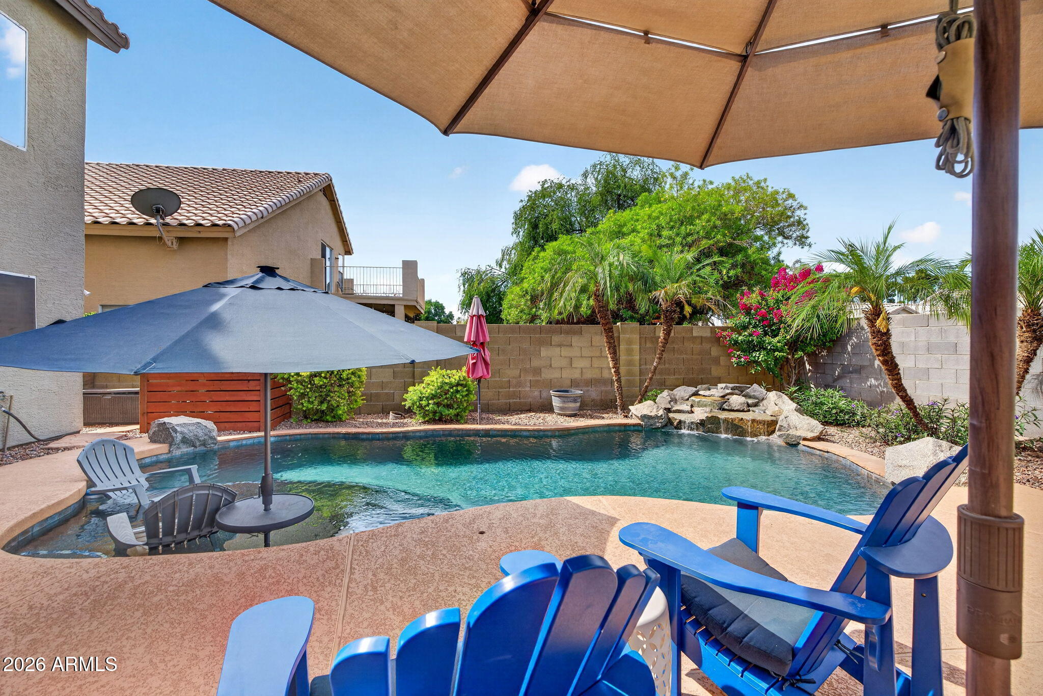 Seller to pay off solar loan with full price offer. Beautiful 4-bedroom, 2.5-bath home with a pool in the desirable Harmon Ranch community in West Chandler. The thoughtfully designed floor plan offers spacious living areas, including custom built-ins and an open flow ideal for everyday living and entertaining. The kitchen features custom cabinetry, granite countertops, a farmhouse sink, and upgraded appliances. Upstairs, the bathrooms and laundry room showcase stylish finishes and functional design. Primary bath was completely remodeled in 2025. Step outside to a private backyard oasis complete with a play pool with waterfall and extended baja step, fire pit, covered patio, and low-maintenance landscaping including turf. There is plenty of room to spread out and take it all in.  AC and pool pump were replaced in 2024 which means less stress for you! This is all in a prime location near shopping, dining, and easy freeway access.