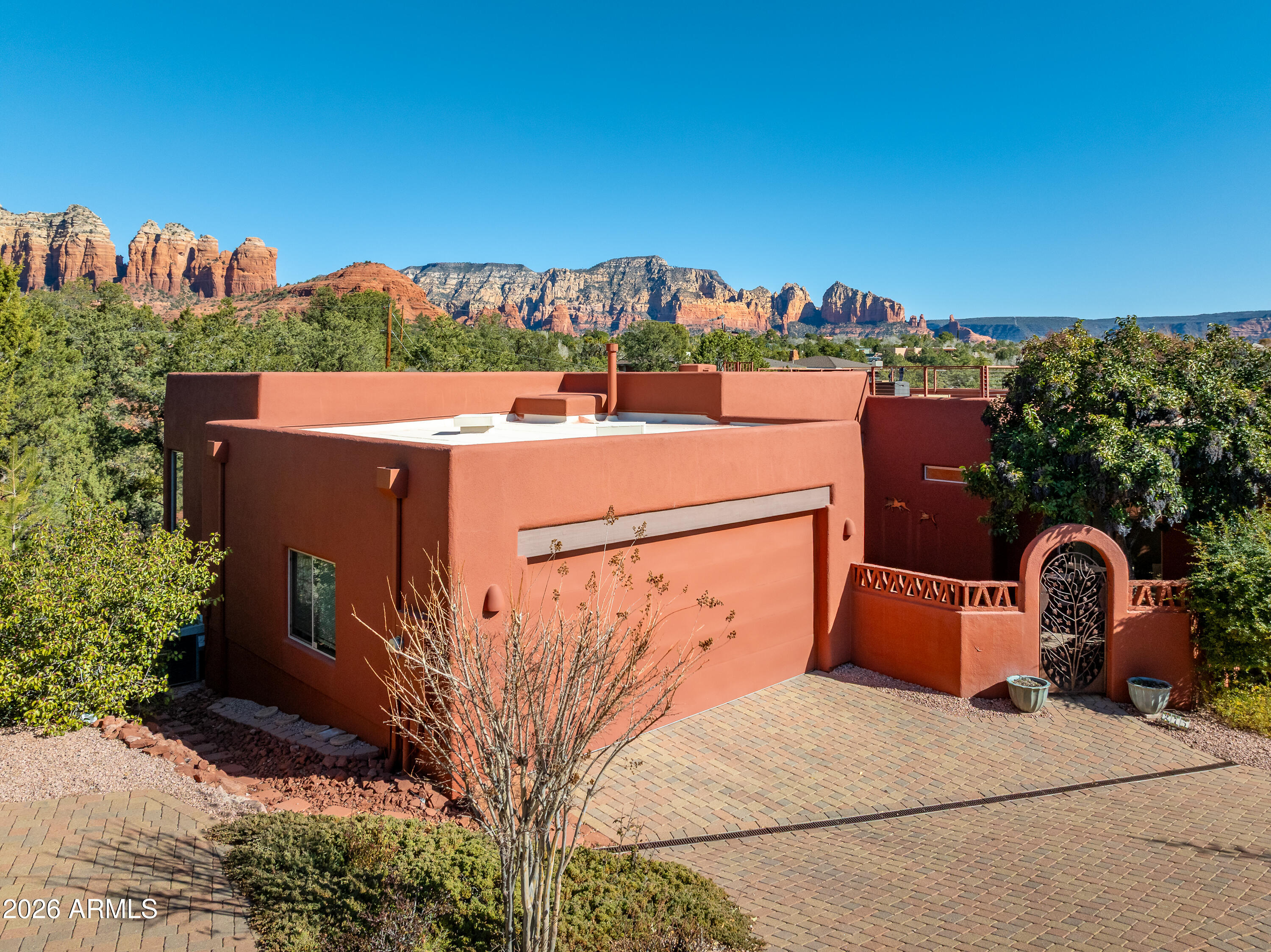 No HOA. Excellent for primary, 2nd residence or Short Term Rental. Spectacular Sedona views take center stage from this exceptional home featuring a private rooftop view deck. Designed for effortless living and entertaining, the open floor plan is filled with natural light and flows seamlessly to indoor and outdoor spaces. Enjoy sunset views from the rooftop deck, or off kitchen deck, host gatherings with ease, and take advantage of abundant storage throughout the home. Conveniently located near shopping, dining, and Sedona's renowned hiking trails, this property offers the perfect blend of scenery, comfort, and accessibility. New roof and heating system. Extra parking space next to the garage.
