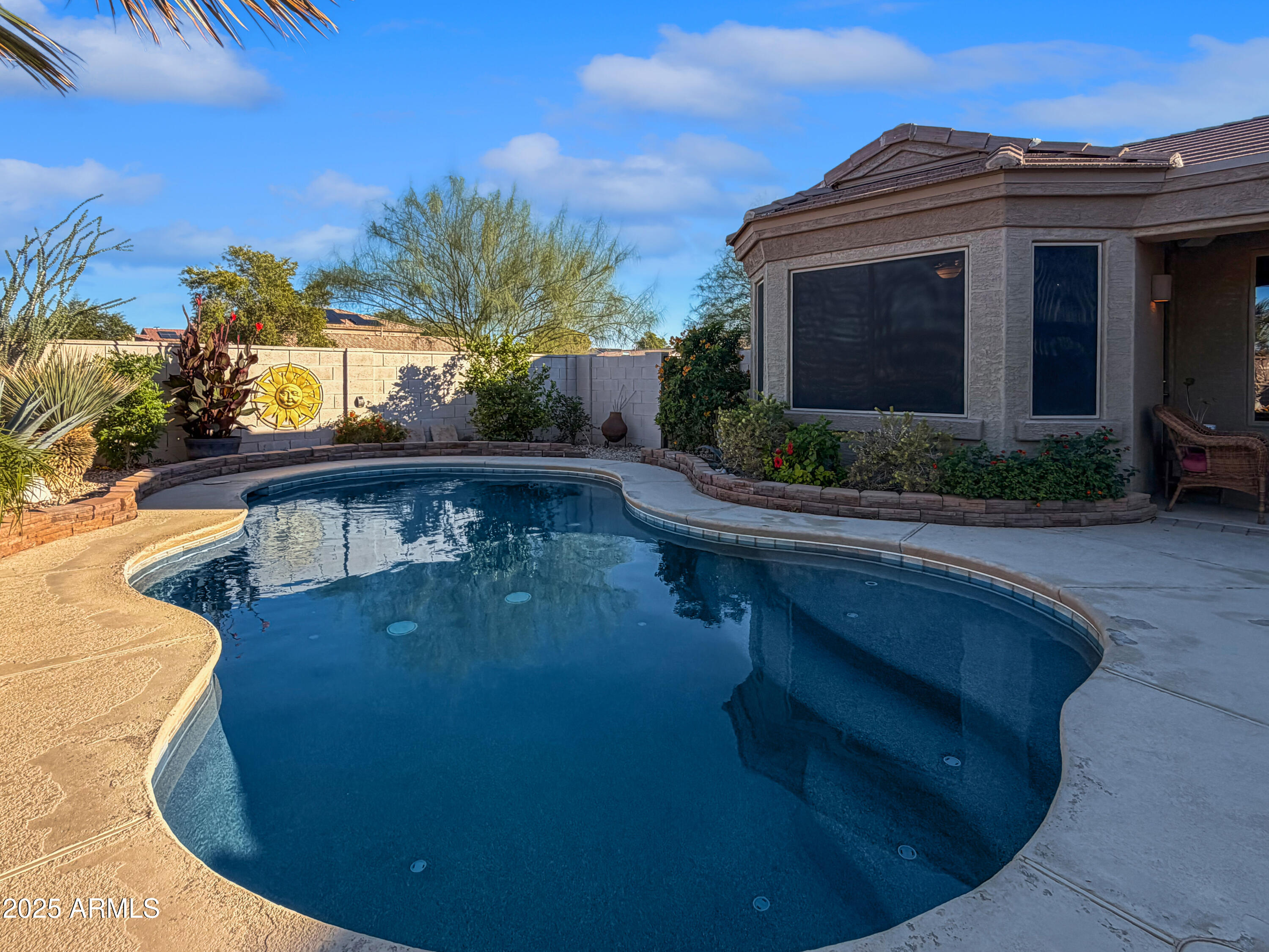 Beautifully upgraded home with private casita and resort-style backyard. This home shines inside and out, featuring a private backyard retreat with heated pool, covered and extended patios, pergola, custom water feature, built-in BBQ, surround sound, shade trees, turfed dog run, and no neighbors behind. Inside, a unique front bedroom has been converted into a private casita with separate entrance and full kitchenette--ideal for extended family, guests, older children, or rental use. The open kitchen flows into the family room with a separate dining area and abundant natural light. Generously sized bedrooms, tile flooring throughout, plus a den perfect for office or flex space. Additional upgrades include newer stainless appliances, extended garage, French doors, soft water, heated spa...