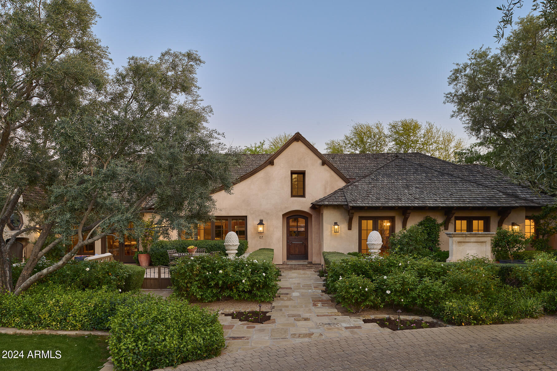 Experience the enchanting blend of rustic French country charm and elegant modern finishes in this beautifully remodeled estate, making it the perfect sanctuary for family living and sophisticated entertaining. Renovated in 2009 by acclaimed designer Tracey McKee and distinguished builder Dan Madison, this home features a masterful addition—a remarkable basement complete with a office, a stylish bar, cozy den, and a convenient 3/4 bath.
Throughout the residence, enjoy the warmth of reclaimed walnut flooring, beamed ceilings, and plaster walls, complemented by exquisite marble countertops and 17th-century French limestone fireplace surrounds that add a touch of historical grandeur.