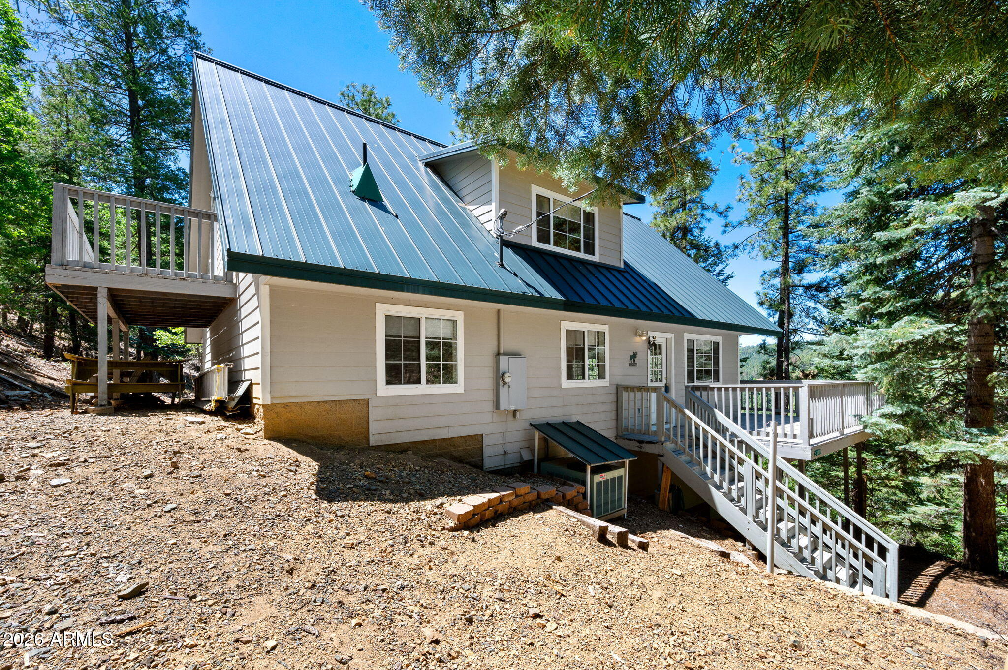 You want privacy? This is the perfect secluded weekend getaway. The road is steep and there is no drive by traffic. Relax in the cool, quiet mountain breeze, sitting on the deck of this secluded 2,195 SF mountain cabin, with 4 beds, 3 baths, with plenty of room for family or friends in 3 stories, with a walk out basement. On 2 hillside acres, you have views for miles. The main floor offers 2 bedrooms, the kitchen, dining room, and living room, with the deck. The wood burning fireplaces will keep you warm on a cool evening. The top floor has 2 bedrooms, with a deck, a bath, and the loft. The walk out basement has the game room, is where the laundry, and a bathroom are located. Enjoy the forest where you'll feel like you're a million miles away. Watch the 'fly through' drone video on YouTube