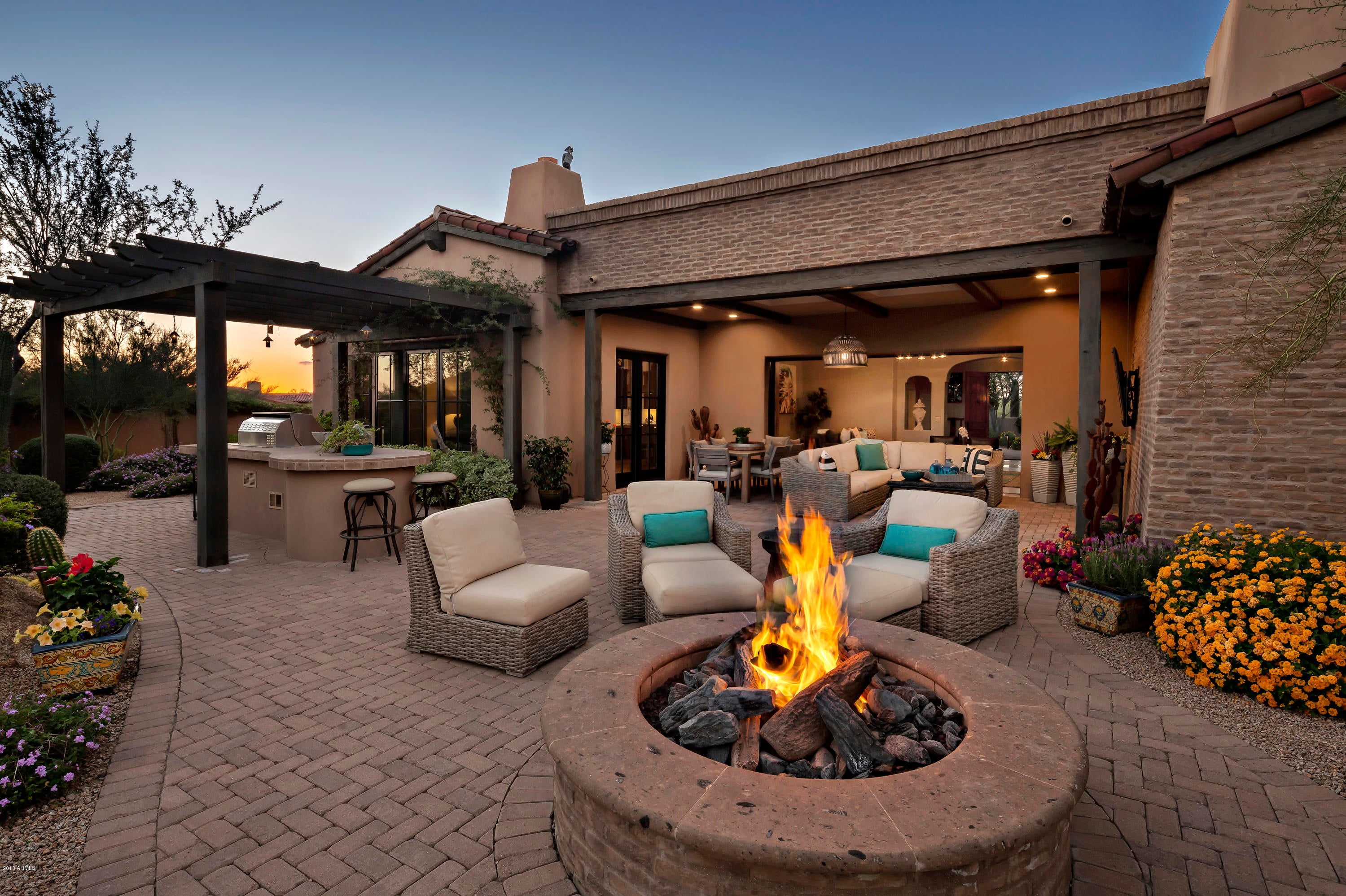South-facing lot with protected views of Pinnacle Peak * Modern twist on a traditional Territorial-style Villa located in the guard-gated community of Whisper Rock Estates * The perfect blend of layout, size, no interior steps, custom finishes and outdoor space * Intimate entry courtyard with stone water fountain and gas fireplace * A true great room floor plan with a wall of glass doors giving way to exceptional views of Pinnacle Peak and the Sonoran Desert * At every turn, every detail has been thought of...stone & wood flooring, beamed ceilings, multiple gas fireplaces, custom light fixtures, professional grade appliances and a temperature controlled wine room * Split master retreat complete with cozy fireplace and completely remodeled bathroom and closet