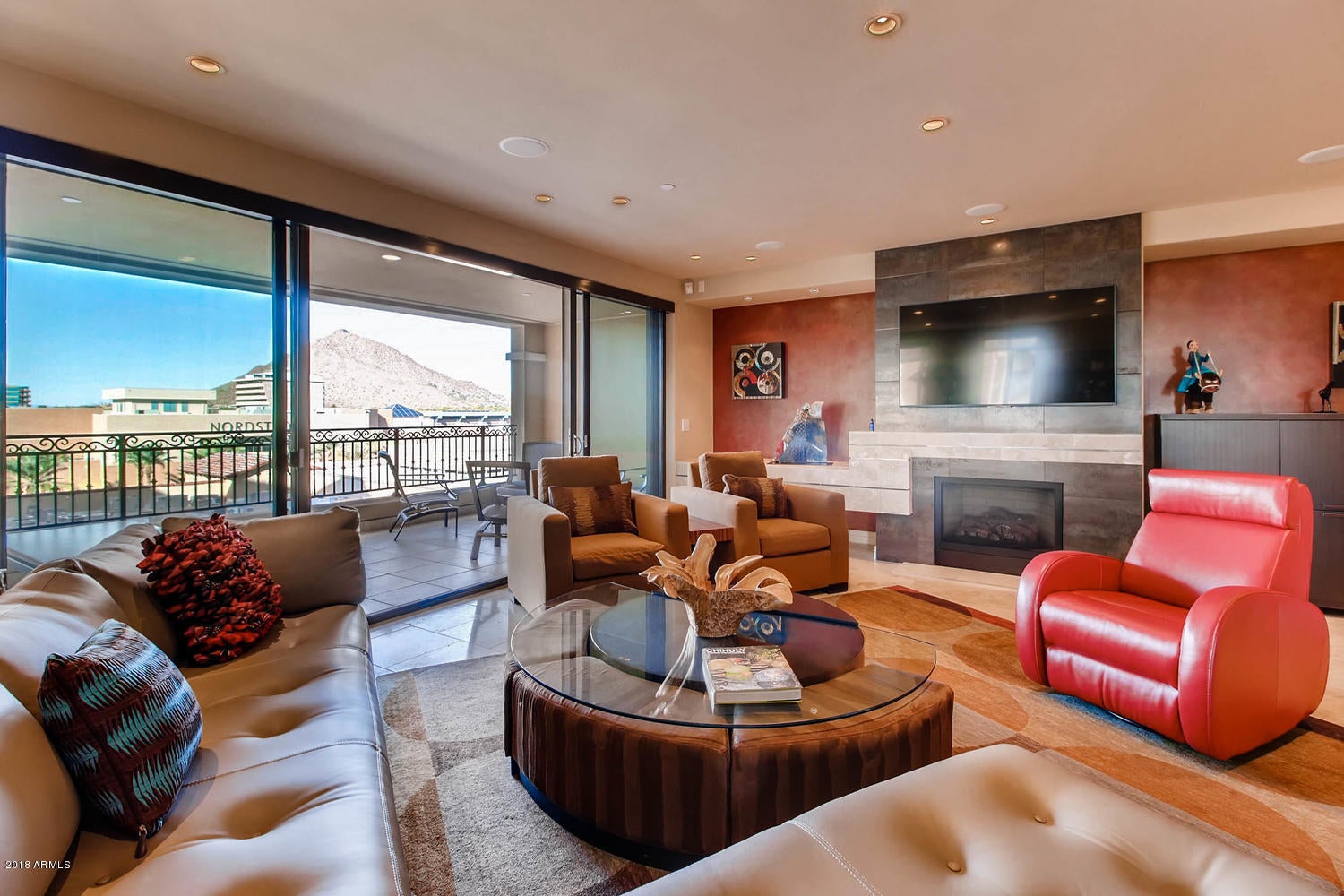 Incredible 7th floor unit gently used by the original owners. This highly desirable floorplan has majestic views of Camelback Mountain, Scottsdale's water front canal, and City Lights. This 2 bed, 2.5 bath and open den condo has been highly upgraded from the striking powder room to the entertainer's kitchen and relaxing master suite. Your chance to live in luxury with 24 hour front desk and valet, full concierge, private underground parking  with 2 spaces, wine storage, massage rooms, up-to-date fitness center and spa. Private parties can be held in the entertainment room with preparation in the Chef's kitchen. Make sure to take in the majestic views from the roof top pool and spa. All within walking distance to premier shopping, galleries, restaurants, nightlife and waterfront fitness.