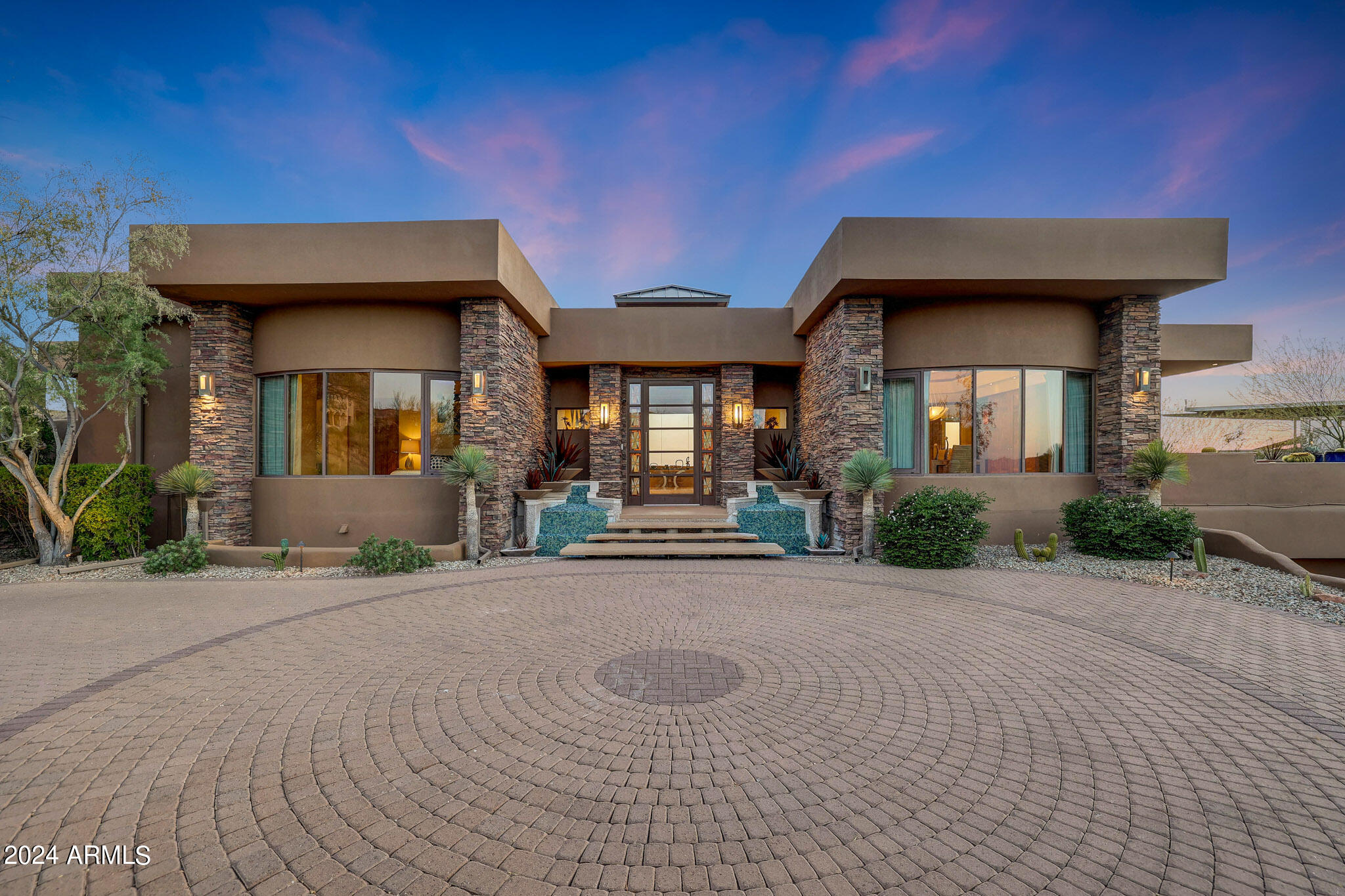 Set amidst the picturesque surroundings of Firerock Country Club, this architectural masterpiece stands on the most coveted street in the community, offering an unparalleled blend of luxury living and awe-inspiring views. Boasting a world-class design with a global inspiration, it showcases luxurious materials such as Turkish limestone, tropical bamboo, Quarto cherry wood, Dutch cabinetry, a top-of-the-line German kitchen, and Japanese-style baths. With four lavish bedrooms, seven well-appointed bathrooms, a spacious four car garage, and thoughtful features like a dog bath, this property offers the ultimate fusion of luxury, comfort, and sophistication. The indoor pool room serves as a tranquil haven, featuring retractable glass doors that open to a lower patio, a kitchen, a comfortable sitting room, a restorative massage room, a rejuvenating sauna, and a luxurious steam bath.  The continuous hot water supply from the Noritz Systems ensures comfort throughout the home.  Other fine amenities include a theater room, game room,  gym, office, and multiple terraces. The expansive outdoor living areas are designed for entertainment and relaxation, featuring multiple patios, enchanting fire pits that enhance the natural beauty of Firerock. Whether unwinding in the elegant Great Room with its Onyx bar, indulging in the peaceful Master bedroom with its lavish amenities, or savoring the natural splendor of Firerock, this residence is truly a masterpiece tailored for the discerning individual seeking the pinnacle of luxury living.