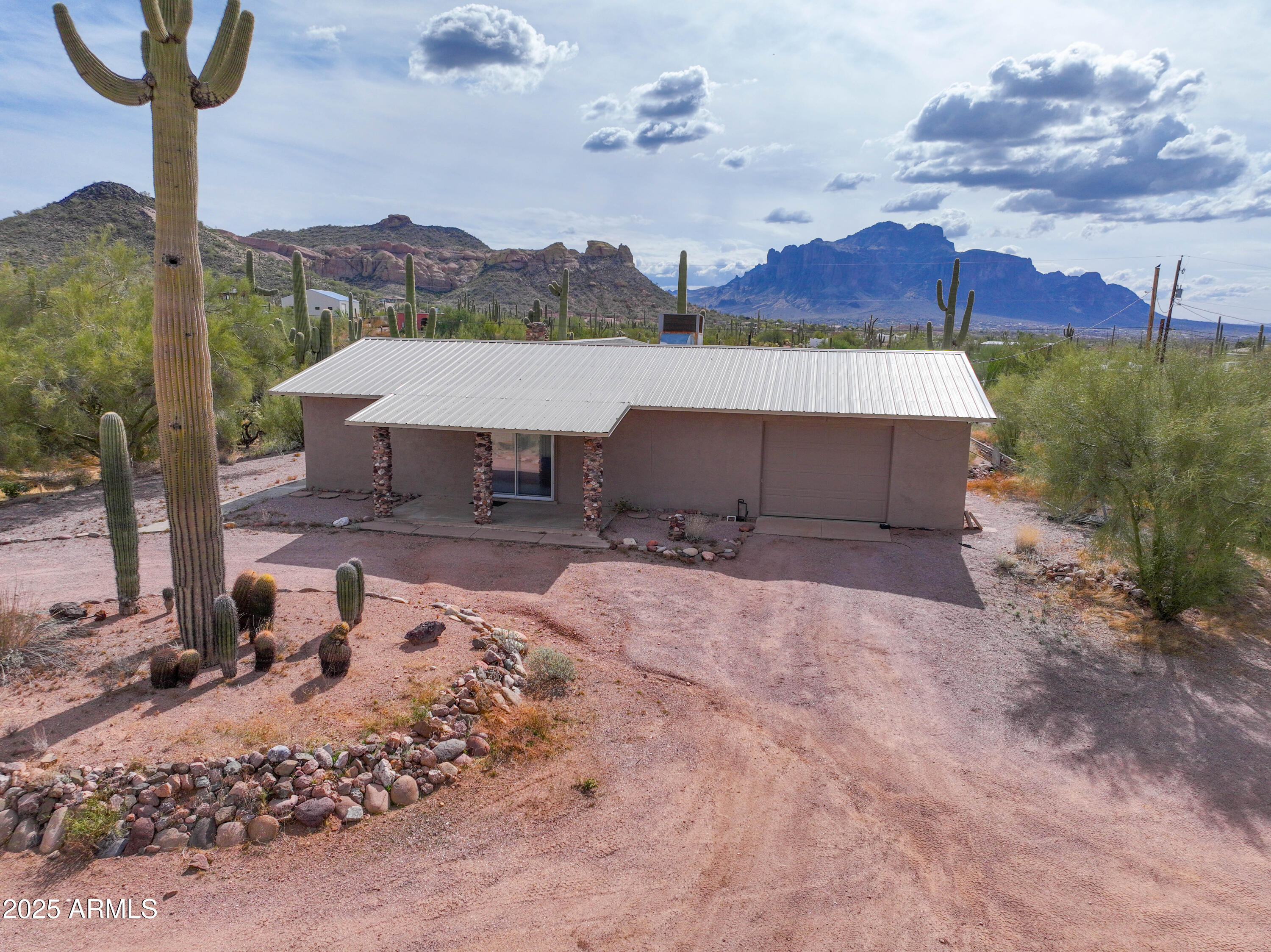 Gorgeous 5 acre lot with stunning views of the Superstition and Goldfield Mountains. Opportunity for Buyers who want space for all their toys or for Investors to develop the land. Main lot has a custom 2bed, 2 bath home, large barn and pen, water well and a tank for hauled water. Other lots have building pad ready.