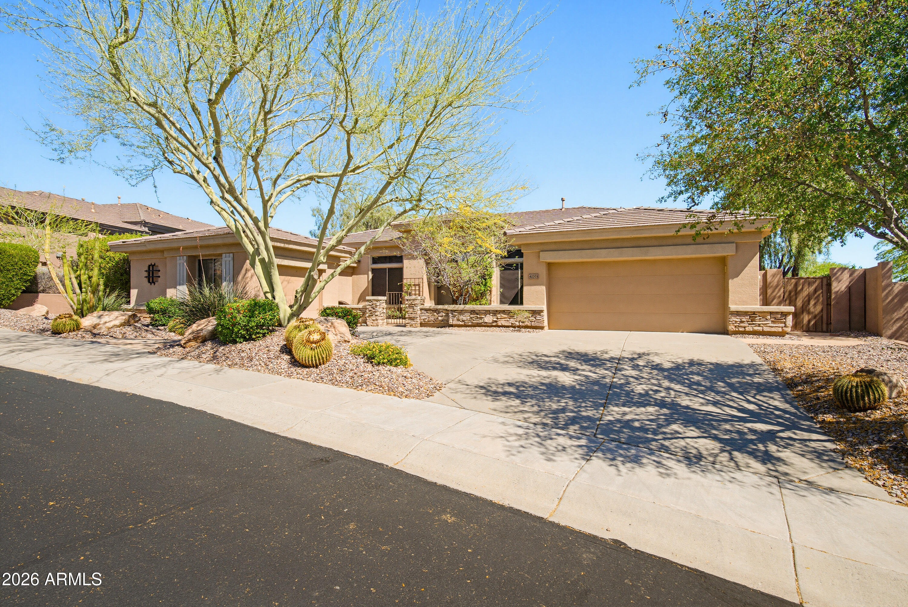 This stunning home is located in the prestigious Anthem Country Club, nestled on an elevated, east-facing cul-de-sac lot with exceptional curb appeal. The generously sized lot offers mountain and city light views. From the moment you arrive, you're welcomed by a warm and inviting courtyard, leading to a grand rotunda-style entrance that sets the tone for the elegance found throughout the home. The thoughtfully designed floor plan features 3 bedrooms, a private office/den, a great room, separate living room, and a formal dining room ideal for both everyday living and entertaining. Interior upgrades include travertine flooring, plantation shutters, crown molding, and a cozy gas fireplace in the great room. Other upgrades  include a new roof (2021), a security system, and a 4-stage water filtration system. The backyard is designed for relaxation and entertaining, complete with a built-in BBQ, hot tub, firepit, and two remote-controlled awnings over the extended covered patio. The home is finished with a highly desirable 3-car garage featuring built-in cabinetry for ample storage.