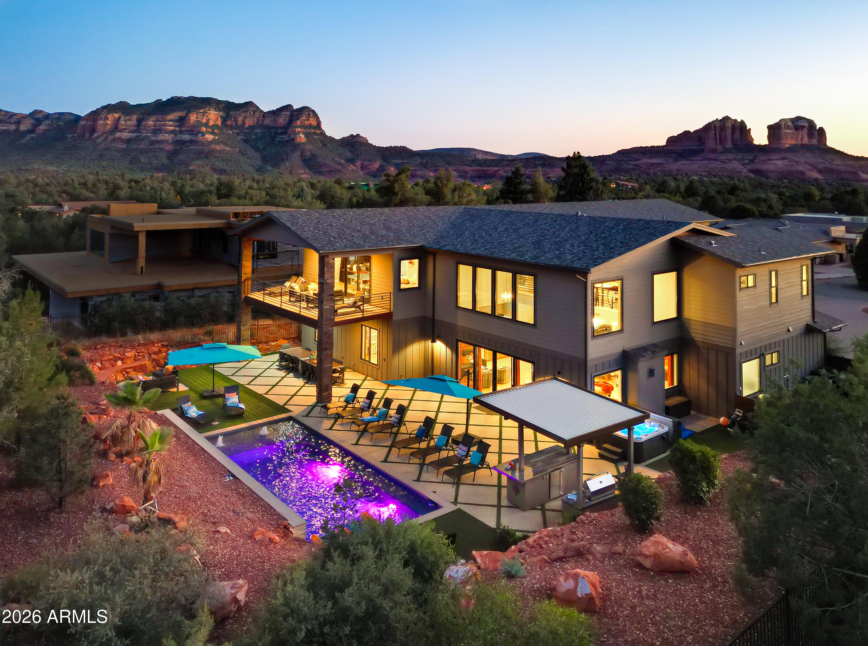 Perched in the heart of Sedona with panoramic Red Rock views in every direction, 49 Eagle Ln is a rare opportunity to own both a show-stopping luxury retreat and a proven, high-performing vacation rental business. This 7-bedroom residence (all ensuite) with 9 bathrooms is designed for unforgettable group stays, featuring a resort-style pool, hot tub, movie theater, media room, game room, private office, ideal for hosting large gatherings with ease.
This is not a 'post and pray' short-term rental. It's a well-established, professionally operated, high-grossing asset in a world-renowned destination. The property has generated nearly $1.9M in gross revenue over the past 3.5 years with documented performance: $353,639 (2022, May 13-Dec 31), $509,884 (2023), $458,881 (2024), $502,426 (2025). Already $435k gross sold for 2026. Since purchase, owners have invested nearly $300,000 in upgrades, enhancing both guest experience and long-term value.
The setting is pure Sedona: iconic sightlines capture Cathedral Rock, Bell Rock, Courthouse Butte, Gibraltar, The Sisters, Elephant Butte, and the Chapel of the Holy Cross. Guests love the unbeatable location--approximately a 10-minute walk to the Chapel of the Holy Cross, walking distance to multiple trail systems, and a short drive to Sedona's dining, shopping, and experiences.
Offered only because ownership is relocating out of state and trading up to a larger investment, this is a standout Sedona acquisition--equal parts lifestyle, legacy views, and income.