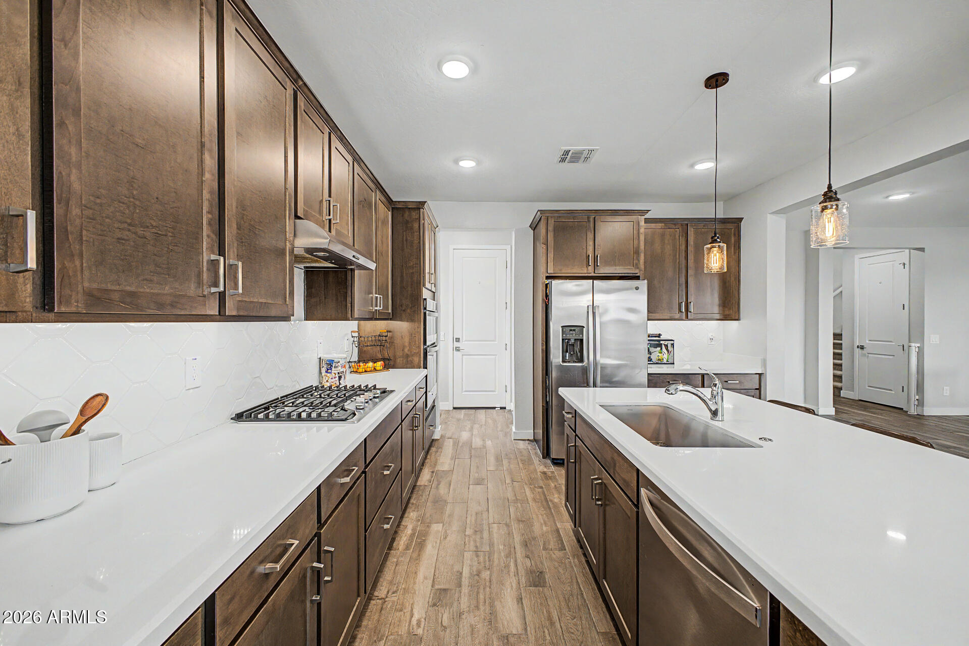 Rare opportunity to secure a VA assumable loan at 3.87%, offering a significant advantage compared to today's market rates and creating immediate value for qualified buyers. Combined with one of Harvest's most sought-after floorplans, this home stands out from the start.
Featuring a private attached casita with separate entrance and dedicated AC, this layout offers a level of flexibility rarely found in this price point. Positioned on a premium lot backing to open common area with mountain views and no direct rear neighbors, the home delivers both privacy and open space.
Inside, the open-concept great room is anchored by a gourmet kitchen with quartz countertops, gas cooktop, built-in oven and microwave, under-cabinet lighting, and the highly desirable combination of a butler's...cont.. and walk-in pantry. A wall of glass brings in natural light and connects seamlessly to the finished backyard with turf and low-maintenance landscaping.
The main level also includes a dedicated office and guest powder bath, while upstairs features a spacious loft, well-appointed secondary bedrooms, and a functional split layout. Additional highlights include wood-look tile flooring, whole-home induct air purification system, and tankless gas water heater.
Located in the amenity-rich Harvest community near Schnepf Farms, Queen Creek Olive Mill, and Downtown Queen Creek, offering convenient access to dining, recreation, and local events. Opportunities combining financing advantage, layout, and location like this are extremely limited.