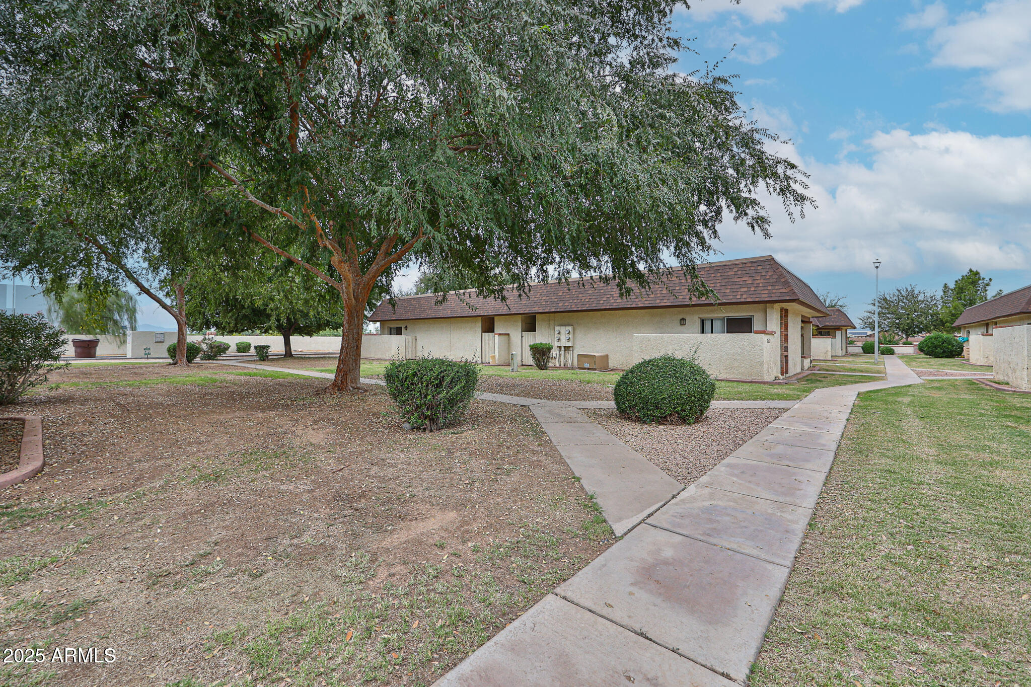 Peaceful interior unit offers a perfect blend of comfort and charm, ideal for anyone looking for a serene living experience. As you approach the property, you'll appreciate the HOA-maintained lawn adorned with mature trees, creating a picturesque setting that welcomes you home. Step inside to discover a bright and inviting space featuring windows that bathe every room in natural light. The heart of the home, the kitchen, boasts painted butcher block counters paired with mostly brand new stainless steel appliances, including a sleek refrigerator, range, and dishwasher. The living areas are enhanced by beautiful laminate flooring, providing a warm and