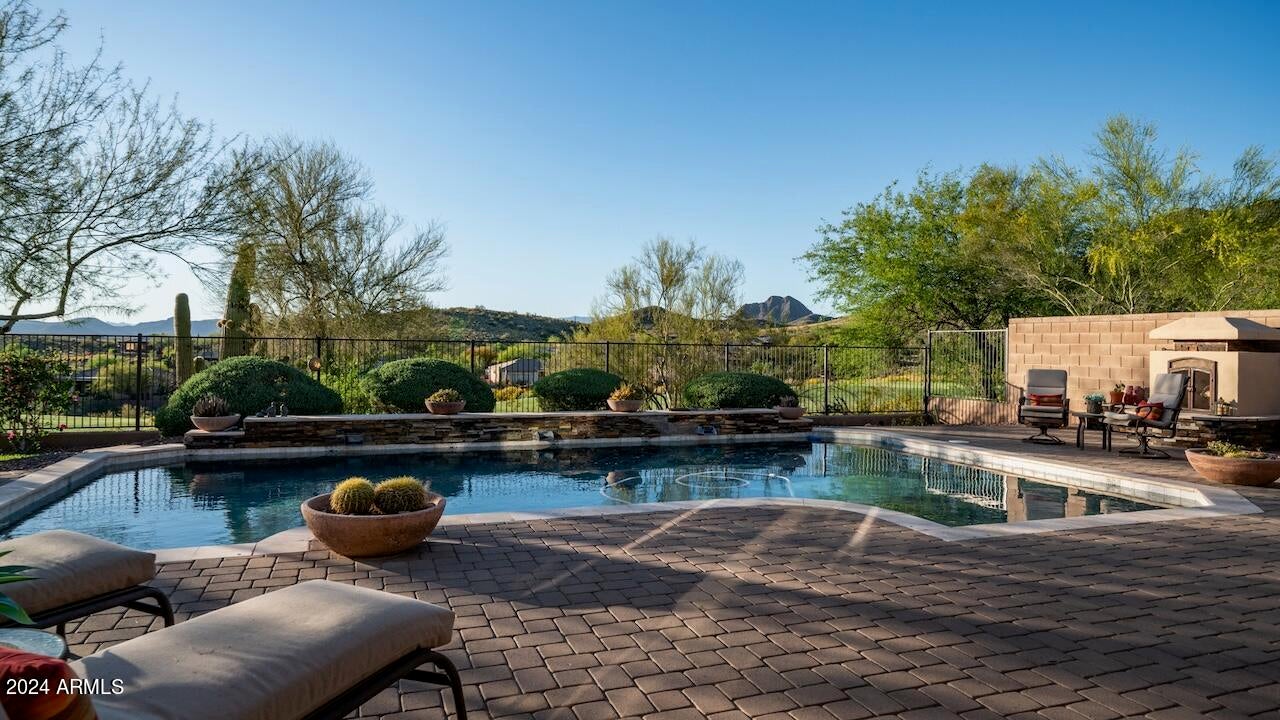 Welcome to your dream oasis in the heart of Anthem Country Club, where luxury living meets breathtaking views and community charm. Nestled on an elevated lot, this exquisite property boasts unrivaled panoramas of the lush golf course greens and the majestic peaks stretching to Daisy Mountain and Gavilan Peak.

Step into a haven of elegance as you're greeted by the warm embrace of a paver courtyard and inviting stone elevation, setting the tone for the impeccable Sonoma model home. Meticulously cared for by its original owner, this residence exudes a flawless allure, evident in every custom detail.

From encased windows to shutters, from the fireplace with a wood mantle and stacked stone surround to updated light fixtures, this home is a testament to refined craftsmanship. Delight in the gourmet kitchen, where granite slab counters, a glass tile backsplash, and raised panel cabinets harmonize effortlessly with custom touches like a range hood and pull-out pantry cabinets.

Entertain with ease in your outdoor paradise, complete with a hot tub, play pool featuring a Shamu Shelf, and a soothing water feature. Fire up the BBQ or gather around the fireplace on the expansive paver patio, adorned with newer remote-controlled sunshades for added comfort on sunny afternoons.

Embrace the spirit of community in this friendly neighborhood renowned for its "Drinks in the driveway" get-togethers, where memories are made and lifelong friendships flourish. Don't miss the opportunity to make this impeccable retreat yours and indulge in the epitome of Anthem Country Club living.