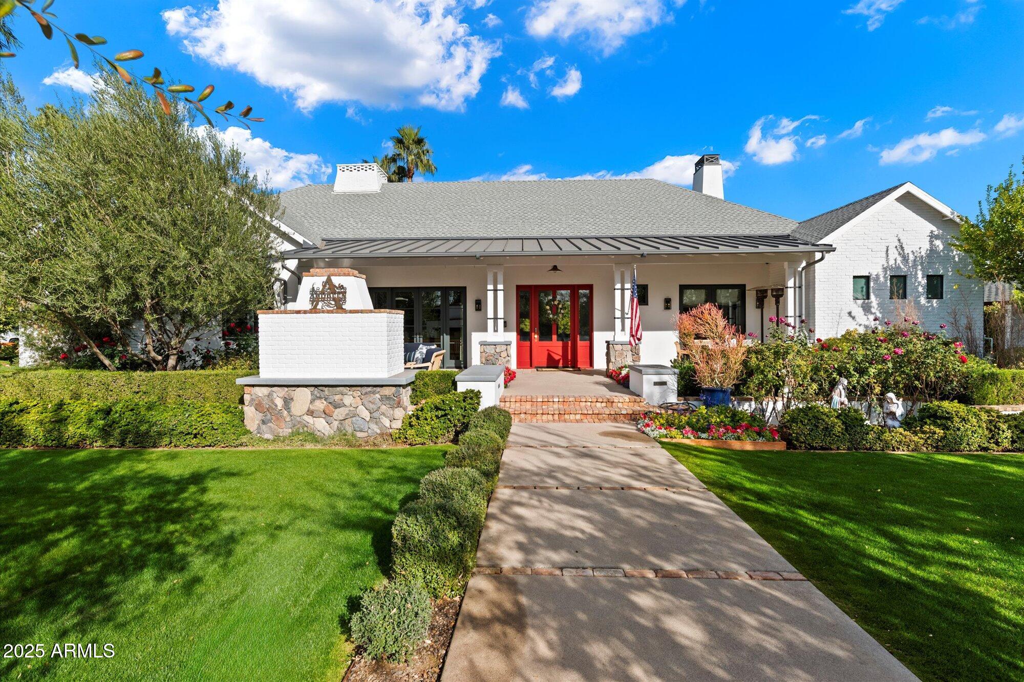 Featured in Phoenix Home and Garden in 2020, this wonderful family home is perfectly situated in the heart of Arcadia proper, yet oh so close to Old Town Scottsdale! This thoughtful design was masterfully created to capitalize on living space for any sized family, and the lush landscaping by Greey /Pickett maximizes outdoor living while ensuring complete privacy. With every detail carefully considered, this home boasts Lightform LED lighting throughout, EMTECK door hardware, and a Control4 home entertainment system, ensuring a blend of luxury, functionality, and modern comfort. Inside, the home offers exquisite finishes and custom details at every turn, including French Oak wide plank hardwood floors throughout, 8-foot solid core doors, and custom built-ins in nearly every room. Expansive dual-pane, hand-crank wood windows and Western Window & Door cascading sliders invite natural light and frame views of the beautifully landscaped yard. The open-concept floor plan is perfect for both family living and entertaining, with an impressive gourmet kitchen featuring Decor Stainless Steel appliances, a separate Sub-Zero refrigerator and freezer, dual dishwashers, and farmhouse sinks. A standout Spekva wood island countertop anchors the space, while a dramatic iron and concrete range hood adds a striking touch. The kitchen also includes a walk-in pantry and coffee bar  ideal for daily use or hosting guests.

The owner's suite is a serene retreat with a spacious walk-in closet featuring custom storage solutions, and a spa-inspired bathroom with a Waterworks Empire freestanding bathtub, an Easton Classic exposed tub filler, and a brilliant sapphire glass surround in the shower. The en-suite bathrooms throughout the home are equally luxurious, with Waterworks fixtures, custom tile work, and high-end finishes. For added convenience, the home includes a full laundry room with a sink and powder bath, as well as a separate office/library with custom cabinetry and garden views.

The main great room features vaulted ceilings with stained oak beams, custom floor-to-ceiling bookshelves, and a frame TV that seamlessly blends into the space. The formal dining room is anchored by a gorgeous chandelier and French doors that open to the outdoor living area, creating an ideal space for entertaining. The lower family entertainment room, measuring 20x28 feet, is designed for movie nights and gatherings, featuring a wet bar, powder room, and a 76-inch Samsung LED surround sound TV. An electric wench in the stairwell ensures ease of maintenance for the dramatic Sputnik light fixture overhead.

The outdoor living spaces are just as impressive as the interior, with a 300-square-foot Southern-style front porch featuring a natural gas fireplace and outdoor dining area. The backyard is designed for ultimate relaxation, with a resort-style pool complete with a fountain and sun deck, perfect for unwinding or entertaining guests. A cooking peninsula with a built-in Turbo Elite grill adds to the home's outdoor appeal, while the landscaping ensures both beauty and privacy.

Additional amenities include a 3-car garage with 300 square feet of conditioned attic storage, a 4-car driveway, and a state-of-the-art ADT security system with cameras for peace of mind. This home offers the perfect blend of style, comfort, and cutting-edge technology, making it one of the most desirable properties in Arcadia.