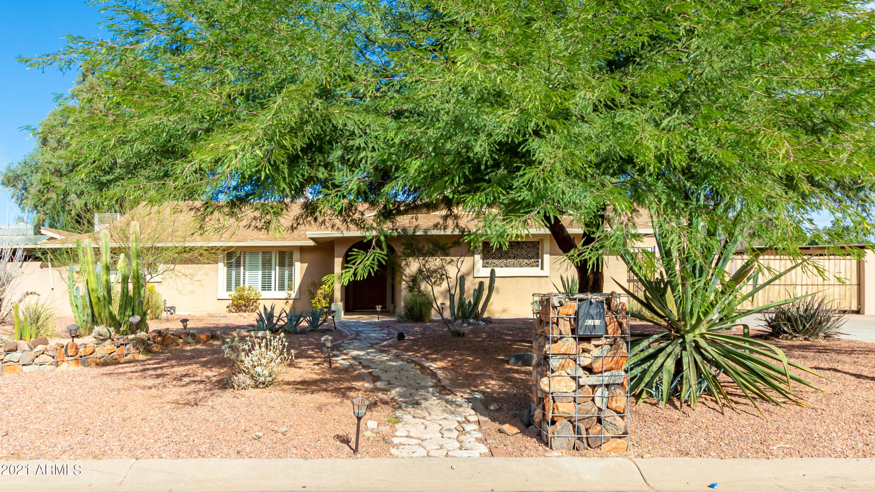 Best of 3 worlds: City of Phx, sought after Scottsdale Schools, and Paradise Valley zip code. Main home is 4BD 3BA with Gourmet Kitchen offers induction cook top with retractable vent, 42in cherry cabinets with self closing drawers and even a spice rack! , granite counters,  travertine floors. The bedrooms are the only rooms with carpet in the whole house! , 10 solar skylights to keep it light and bright, solar hot water, whole house surround sound and a huge laundry room all on a 3/4 acre lot with pool and covered patio area great for entertaining all of your guests or you could add a spa. This home also has a sep. guest house (1150 Sq. Ft.) with 2BD 2BA, kitchen and great room, storage galore, it's own laundry incl. sep. washer & dryer, walk in pantry and tile throughout. It has elec. parking gate for main home, 3 workshop / storage areas under 1 roof, covered RV parking area measuring 33' X 10.6', 3.5G and an oversized 28x20 carport for the guest house