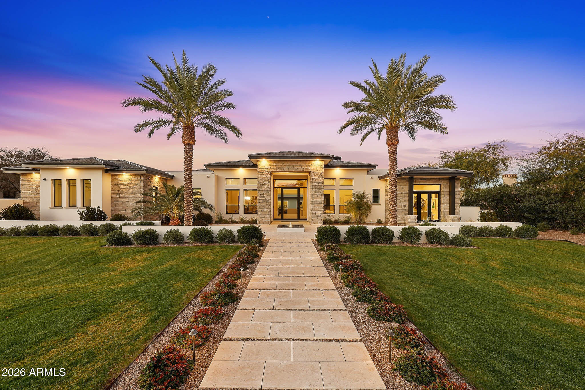 Premier Paradise Valley living with breathtaking Camelback Mountain views. This exceptional Forte Homes residence is ideally positioned in one of PV's most desirable locations and offers a rare blend of modern architecture, resort-style outdoor living, and elevated luxury finishes throughout. The main residence spans 6,509 sq ft and is complemented by a 575 sq ft detached guest house, creating a total of 6 bedrooms and 6.5 bathrooms. Designed with a desirable split floor plan, the home features an expansive great room with soaring ceilings and dramatic wood beam details in both the living and dining areas. Walls of glass seamlessly connect indoor and outdoor living spaces, perfect for entertaining. The chef's kitchen is equipped with Sub-Zero and Wolf appliances and opens to the great room, while additional interior highlights include a private office, formal dining room with a stunning climate-controlled wine room, and a versatile flex room with an indoor/outdoor bar. High-end wall coverings throughout, along with Rocky Mountain Hardware, Visual Comfort lighting, Control4 smart-home automation, Taj Mahal quartz throughout, and luxury engineered hardware at every turn.  The resort-style backyard is a true showpiece, framed by rows of gorgeous, mature palm trees and designed for both relaxation and recreation. Outdoor amenities include a large heated pool and spa with water features, multiple covered patios, fire features, lush landscaping, and a full-size pickleball courtcreating a private oasis ideal for year-round enjoyment.

The detached guest house offers full living accommodations, including a living area, kitchen, and bathroomperfect for guests, extended family, or a private retreat.  Additional features include a gated driveway, four-car garage with 12' ceilings, premier neighborhood setting, and close proximity to top-rated schools. A rare opportunity to own a refined, move-in-ready luxury estate in the heart of Paradise Valley.