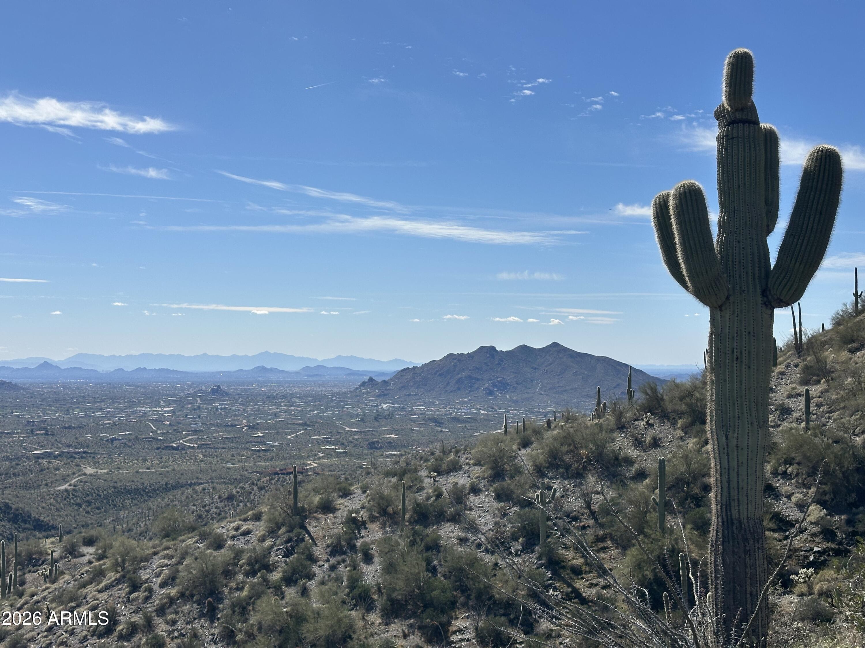 12.4 Acre homesite with top of world views! Absolute privacy from this lofty perch atop the guard gated community of Carefree Ranch in North Scottsdale. Sited with views overlooking the entire valley of the sun, the desert comes alive with views of surrounding mountains both intimate and long distance including Apache Peak, the Homesteads, The Continentals, Four Peaks, Weavers Needle, the McDowells Troon area mountains, Pinnacle Peak and Mexican Hat rock formation. From Sunrise to Sunset the colors of desert pop and as the sun goes down the mountain silhouettes are formed and city lights shine! Rare opportunity to combine this lot with the adjacent listing (MLS 6962311) for a total of 36 acres+ over three home sites! Optionality allows you to build a single home on this site, or if combined with other lots, a family compound on one large homesite, or up to three single family homes each on 12 acres or hold the land for investment. 4 horses allowed per residence unless committee approves more. Private and tranquil, yet quick access into Scottsdale, Carefree, Cave Creek for shopping, dining, biking, hiking, and golfing!
