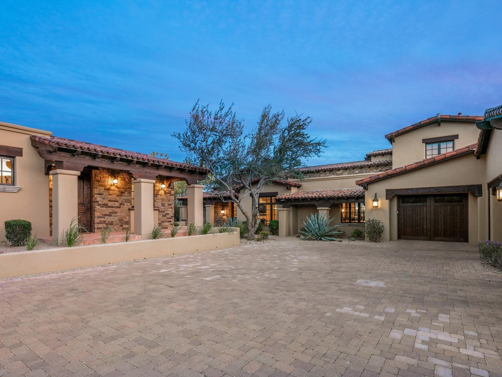 Spectacular estate ideally located on the 11th fairway at DC Ranch Country Club.  This fabulous home offers sweeping golf course, mountain, and city views!  Meticulously designed floor plan offers plenty of space with an open kitchen featuring a large granite island, gorgeous wine wall, and a lovely dining area with sophisticated groin ceilings. Beautiful bar area with accordion windows looking out to the golf course and a comfortable living area are complemented by stunning oak plank flooring and handcrafted cabinetry that run throughout the home. Owners installed all new stylishly contemporary light fixtures that suit the home perfectly.  Spacious master bedroom features beautiful wood ceiling beams, beehive fireplace, large walk-in his and her closets, laundry facilities and phenomenal views through glass doors that provide access to the outdoor patio. This home was designed for gracious hospitality with a two guest suites downstairs (one currently used as an office) guest living area and en suite upstairs and a lovely, detached guest casita with wet bar.  The garage features a car lift which expands its capacity to five cars. The outdoor living space of this home is incredible with a massive outdoor covered patio including complete outdoor kitchen, gas fireplace, heated pool and spa and access to the bar that serves both inside and out.  The patio also features motorized shades and a recently updated mister system and ceiling heaters, guaranteeing Arizona outdoor living at its finest!