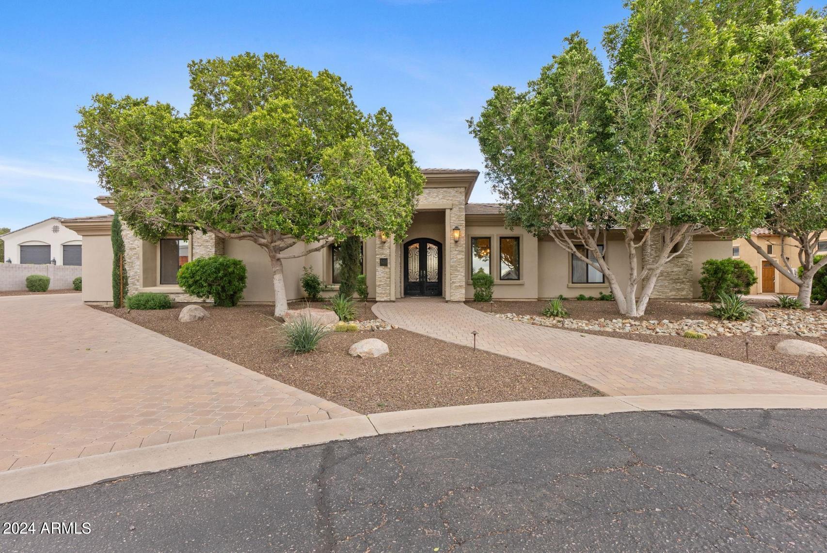 **Voted Best Home on Luxury Tour** Resort living in this exceptionally designed custom-built home on over half an acre, nestled in a private gated community of single-story homes, close to freeway access. The home boasts an open concept floorplan and includes a chef's dream kitchen featuring an oversized island, professional grade double ovens, 66'' wide refrigerator/freezer, gas cooktop, complete with a butler's pantry and oversized walk-in pantry. The great room provides a seamless blend of indoor/outdoor living through the oversized sliding glass doors that open to the extended covered patio to the awaiting backyard oasis. The backyard features a stunning pool, built-in BBQ, firepit and putting green - all surrounded by mature trees. The home also features an office, formal dining large bonus room and laundry room with custom built ins and lockers. An oversized deep 4 car garage PLUS workshop means there's plenty of room for all your storage needs. Don't miss out on this exceptional opportunity!