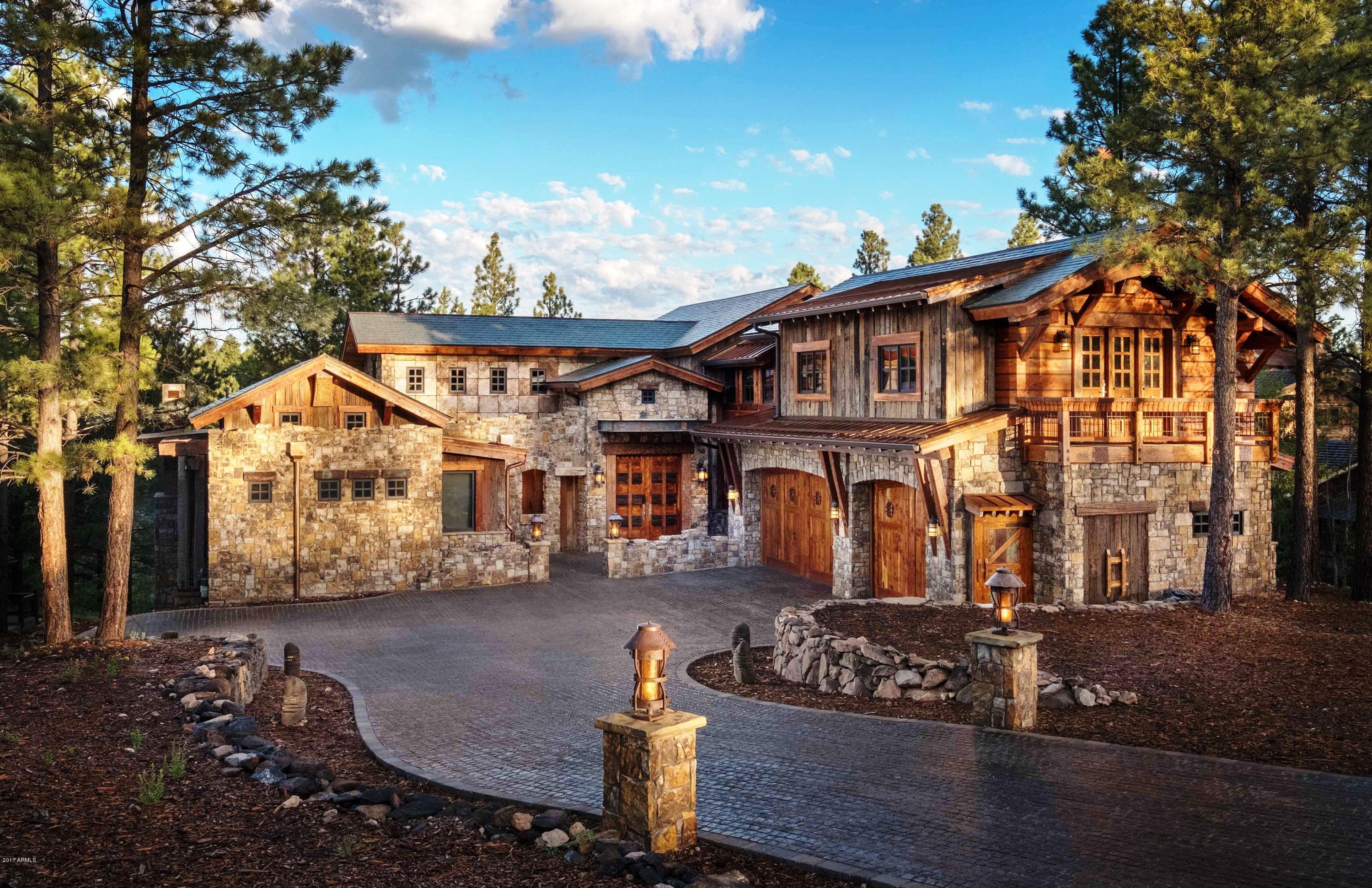 When it comes to one-of-a-kind mountain luxury, the decadence is definitely in the details for Pine Canyon's newest resale listing. The 7,273-square-foot, three-story custom estate is laden with intricate, hand-crafted design that folds together stone, iron and wood in ways that feel at-once contemporary and authentically rustic. Hand-selected, reclaimed teak is featured prominently throughout the five-bedroom, five-and-a-half bathroom home. Each of the home's ornate pillars and every carved ceiling panel were chiseled by Indonesian woodcarvers and craftsmen using centuries-old techniques sourced over the course of nearly 20 years by the home's owner, who is an experienced furniture designer.

The owner worked with indigenous craftsmen more than 8,000 miles away to create aesthetically-unique pieces, from the kitchen cabinets to the vanities, the flooring, the doors, the ceiling and floor panels, and the exquisite kitchen island. Points of distinction throughout the home include the use of 150-year-old iron ceiling panels as exterior siding, utilizing 200-year-old iron wood from a railroad bridge in Borneo as posts and beams for the home's sprawling deck, and the construction of a 30-foot interior bridge using reclaimed posts and flooring.

The homeowner relied on the talents of 200 woodworkers, supplies from several Indonesian villages and the vision of award-winning architecture firm Centre Sky to design and build a home that is unlike any other. Set on a lot that is just over a half-acre, and overlooks Trout Creek Park, the home envelopes the outdoors with a sweeping back deck designed with entertaining and relaxation in mind. Pocket doors, used throughout the home, allow for a seamless flow between indoor and outdoor living.

Inside, the contemporary, open kitchen is equipped with a four-burner Wolf range and Sub-Zero appliances, while the home's atmosphere is regulated by a custom humidifier.