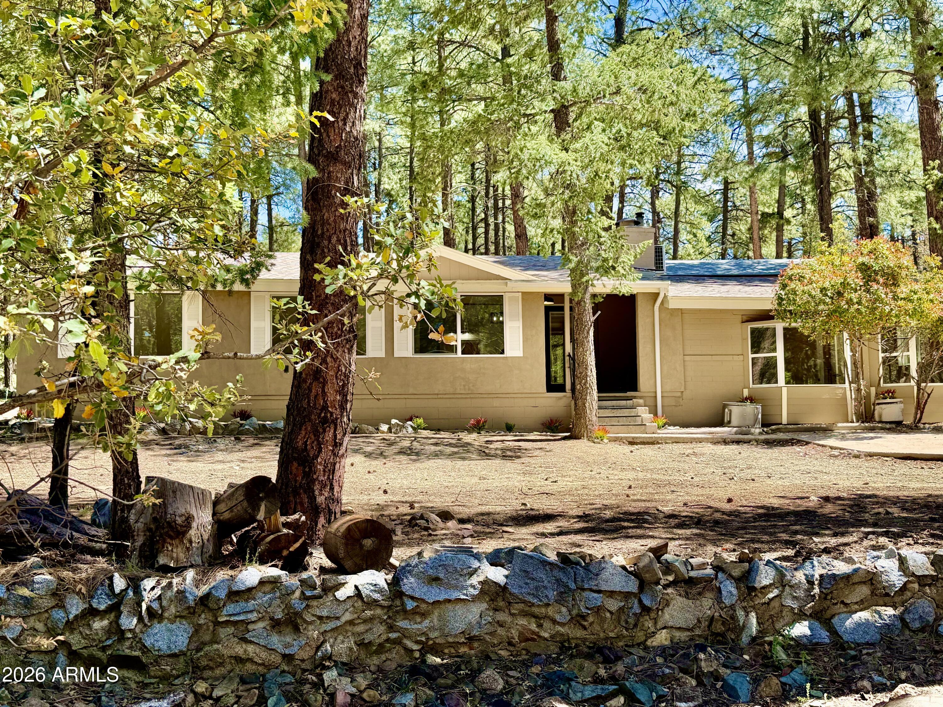Live in the Forest Without Leaving Town! This is the kind of home people move to Prescott for. Tucked into the Prescott National Forest in the heart of Groom Creek, this fully renovated home offers the rare balance of true forest living with all the modern comforts and the convenience of being less than six miles from town, all on paved roads. Inside, the home has been completely renovated floor-to-ceiling, with certain elements preserved, such as the original fireplace surround and the wood flooring (refinished and stained) in the dining area. Enjoy forest views through new windows, or your morning coffee by the new forest-friendly electric fireplace. One of the most unique features is the separate family/flex living area with one bedrooma 3/4 bath, and a kitchenette. Thoughtfully desig this space can function beautifully as a rentable studio, guest suite, multi-generational living for extended family, a teen or kids' hangout space, or a private home office or creative retreat. Outside, the setting is pure Groom Creek: frequent wildlife sightings, immediate access to nature, and a neighborhood that feels tucked away yet connected. You're located right next to the park and fire station, with trail access just down the street, making it easy to step outside and explore whenever the mood strikes. A true standout for the area, this property also includes a two-car garage with new door and openera rare and valuable feature in Groom Creekadding convenience, storage, and year-round practicality. Whether you're looking for a full-time residence, a flexible multi-use home, or a place that feels like a daily getaway, this property delivers something increasingly hard to find: peace, privacy, flexibility, and proximityall in one place. This isn't just a home in the forest. It's getting awayclose to home.
