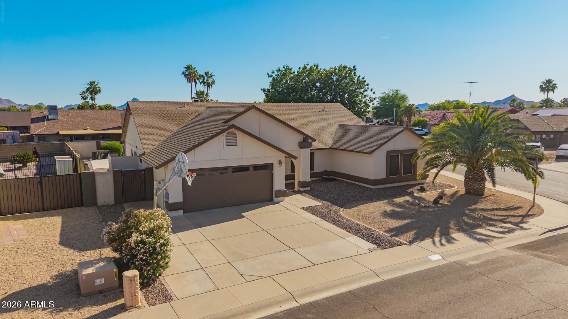 Welcome to Royal Estates East -- a beautifully updated North Phoenix home on an oversized corner lot complete with a pool and no HOA.

Located in the highly sought-after 85032 corridor, this home offers unbeatable convenience with quick access to the State Route 51 and Loop 101 Freeway, placing you just minutes from Scottsdale, Kierland, and Desert Ridge. Enjoy nearby shopping, dining, and entertainment at Desert Ridge Marketplace and the rapidly transforming Paradise Valley Mall area, along with top-rated schools in the Paradise Valley Unified District.

From the moment you arrive, the pride of ownership is evident: mature landscaping, RV gate access, and extended parking offer space for all your toys. Inside, soaring vaulted ceilings with exposed wood beams make a dramatic statement, while plantation shutters, updated lighting, and tile flooring add warmth throughout.
The great room centers around a striking floor-to-ceiling brick fireplace, flowing seamlessly into the dining area and chef-inspired kitchen complete with abundant cabinetry, solid surface quartz countertops, custom bronze stainless steel appliances, a prep island with breakfast bar, and a bay window breakfast nook overlooking the backyard.
The split floor plan delivers privacy and flexibility, with generously sized secondary bedrooms and a primary retreat featuring new carpet, French doors to the backyard, and an updated ensuite with rain head shower, dual sinks and barn door accent.
Out back, a covered patio, sparkling pool, hot tub provisions and ample yard space create the perfect setting for entertaining or relaxing.

Additional highlights include RV gate + extended parking, dual-pane windows & plantation shutters, new refrigerator, water heater, and washer (within last 6 months), & the no HOA gives you the opportunity to turn this home into an income producing short term rental/Airbnb/VRBO, Assisted housing, etc.