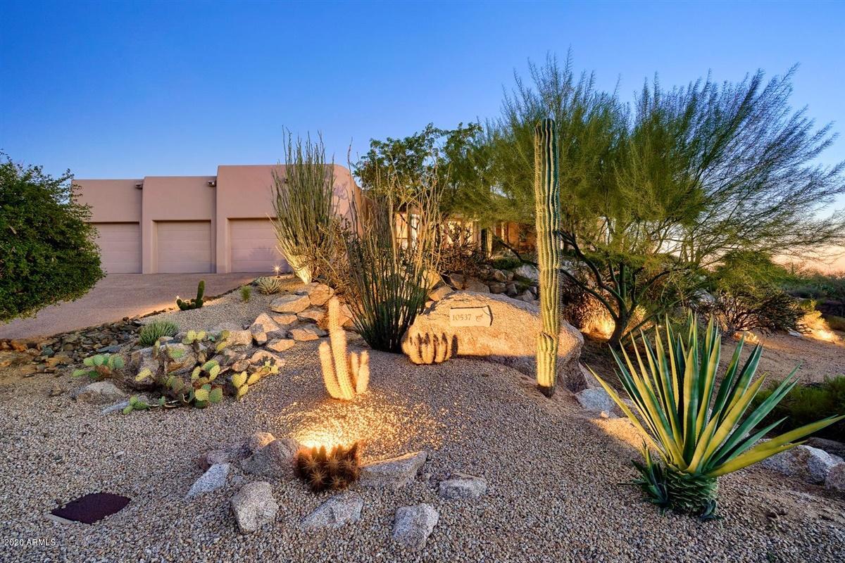 Enjoy Troon North living at it's best from this gorgeous elevated custom home featuring a  South facing backyard with amazing City Lights, Golf Course, Pinnacle Pk, Sonoran Desert and breath-taking sunset views all situated on nearly an ACRE in the guard gated Community of Candlewood Estates. The great room design features a  soaring alder wood ceiling, wet  
bar and dramatic views to the terraced patio with multiple seating areas. The spacious kitchen is every chef's delight, featuring new   appliances, 2 ovens, granite counter tops, large island, formal & informal dining perfect for entertaining. The large master suite boasts views that everyone would love to wake up to.  The resort style backyard features heated pool, spa, water feat. fire pit,  BBQ , sur/sound & observation deck.