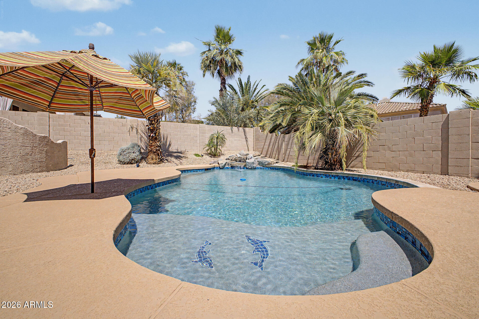 Ocotillo living in Chandler at its finest! Large, elevated corner lot with almost 3500 sf of living space. 5 roomy BRs, 3.5 BAs (ensuite downstairs), den, and bonus/media room off the great room. Kitchen features an expansive granite island, Blanco sink, RO system, pull-out shelves, lighted cabinets/under cabinet lighting, wine fridge, trash pull-out, and SS appliances. W/D, storage closets, freezer, fridge in laundry room. Soft water system. Luxurious spa-like primary bedroom ensuite features a stand-alone soaker tub, multi-head shower system, stunning cabinetry, and thoughtful niches for your personal care needs. 2021 remodeled pool, BBQ island, spa, grassy areas and expanded covered patio. New roof, AC 2021, new int paint 2026. Original owner. Near tech corridor, 101, 202, A+ schools!